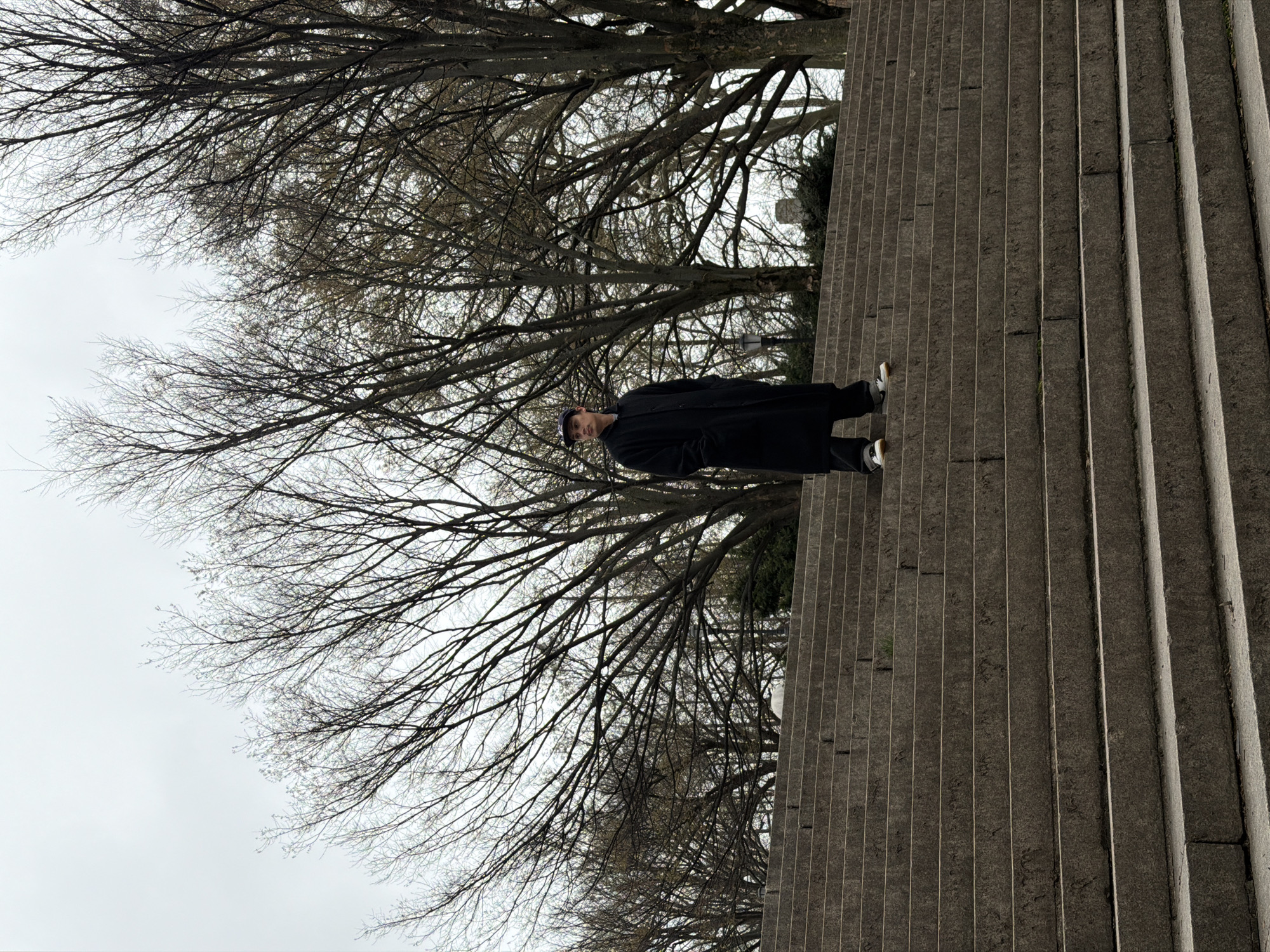 Figure in black coat spotted on NYC stairs near park