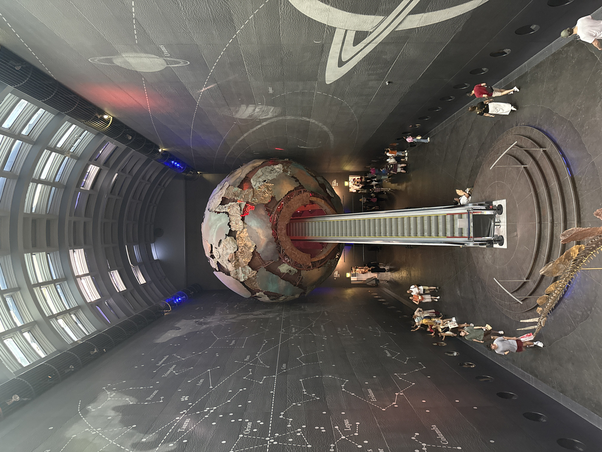 Giant suspended planet sphere dominates a London science center interior