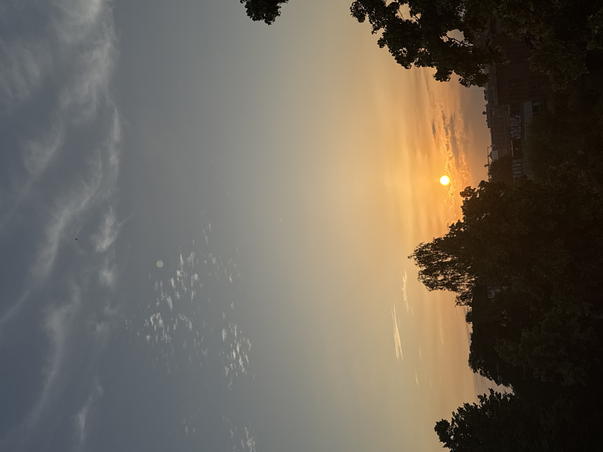 Summer solstice sunrise over Lübeck streets and sky