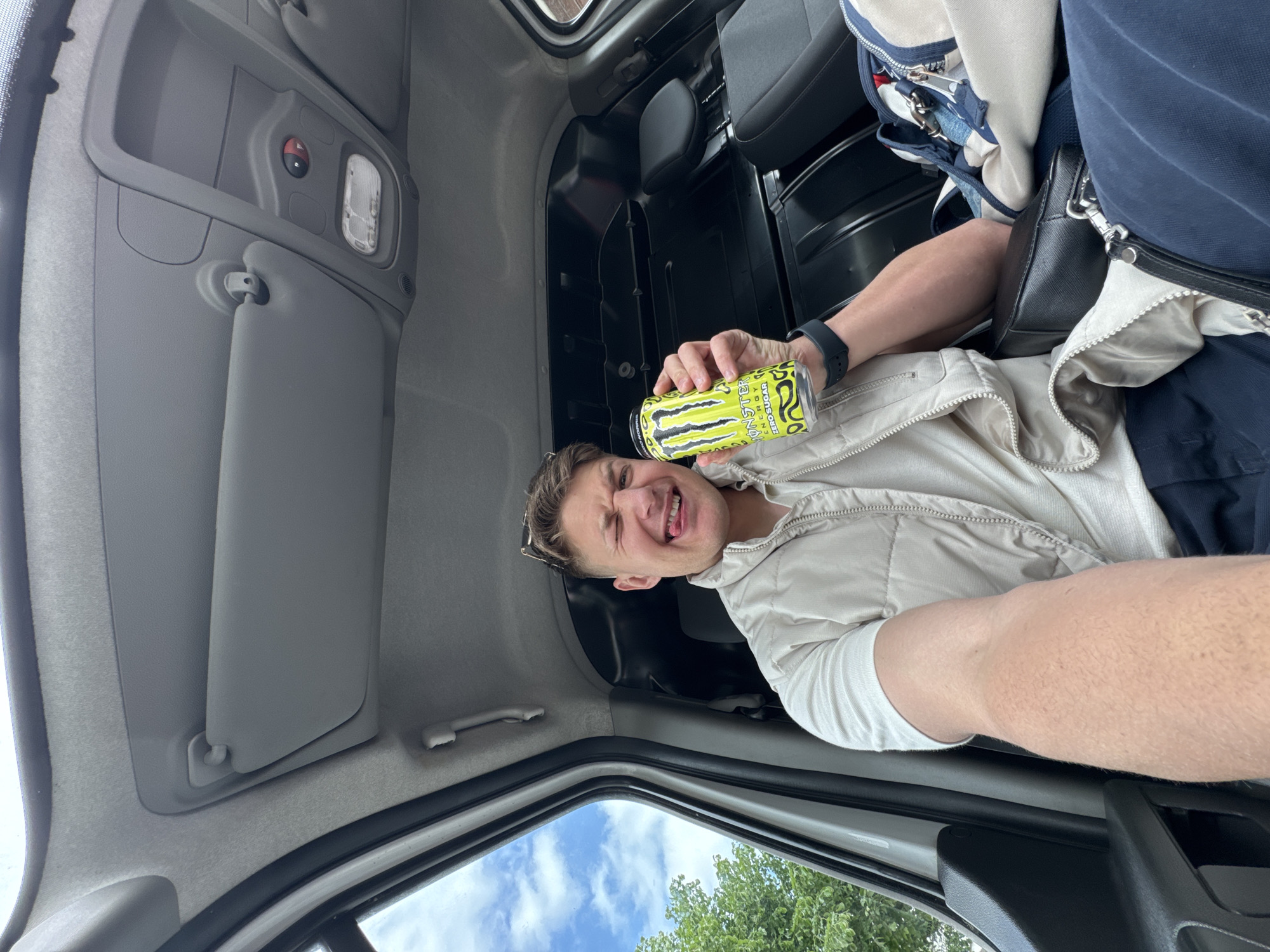 Taxi driver poses with energy drink, dog in Bulgaria