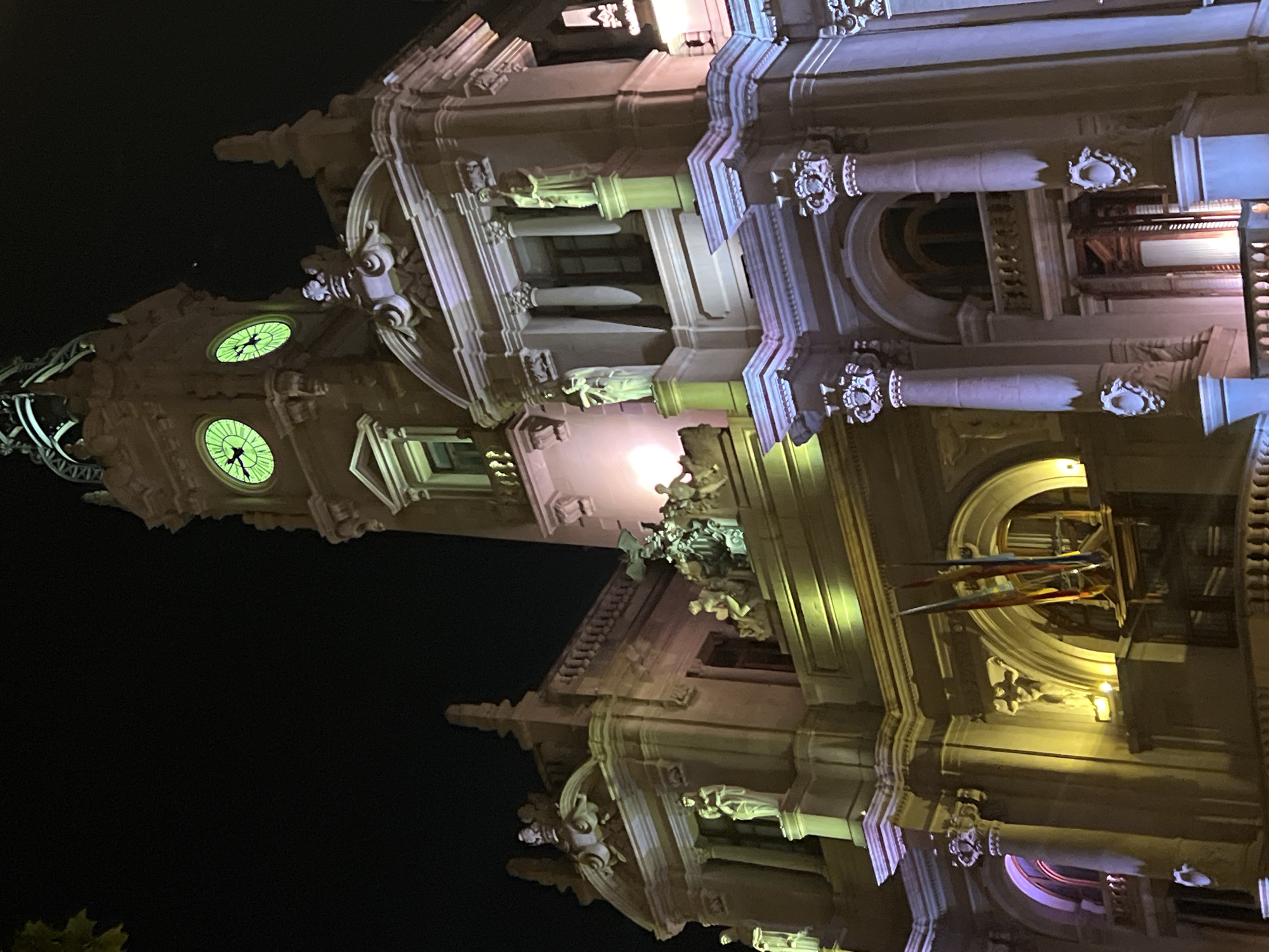 Valencia City Hall illuminated at night draws multiple observers