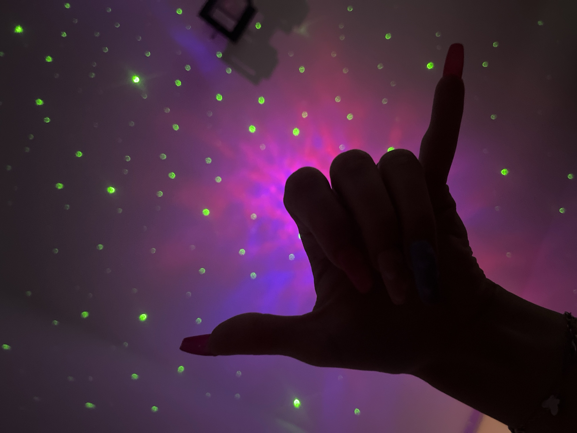 Hand gestures captured against colorful lights in Plovdiv Bulgaria