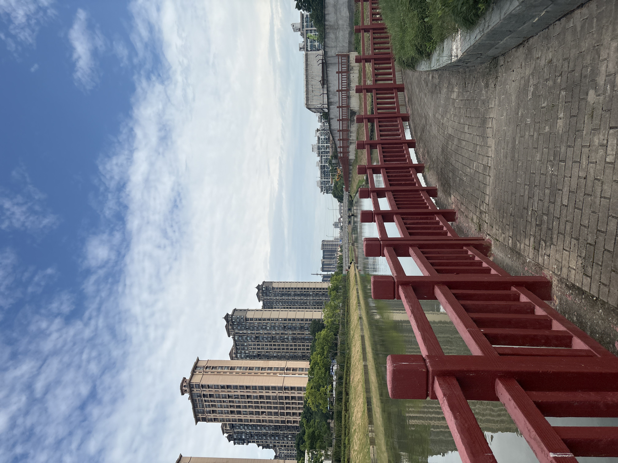 Morning stroll along a Minhang canal promenade, July 2026