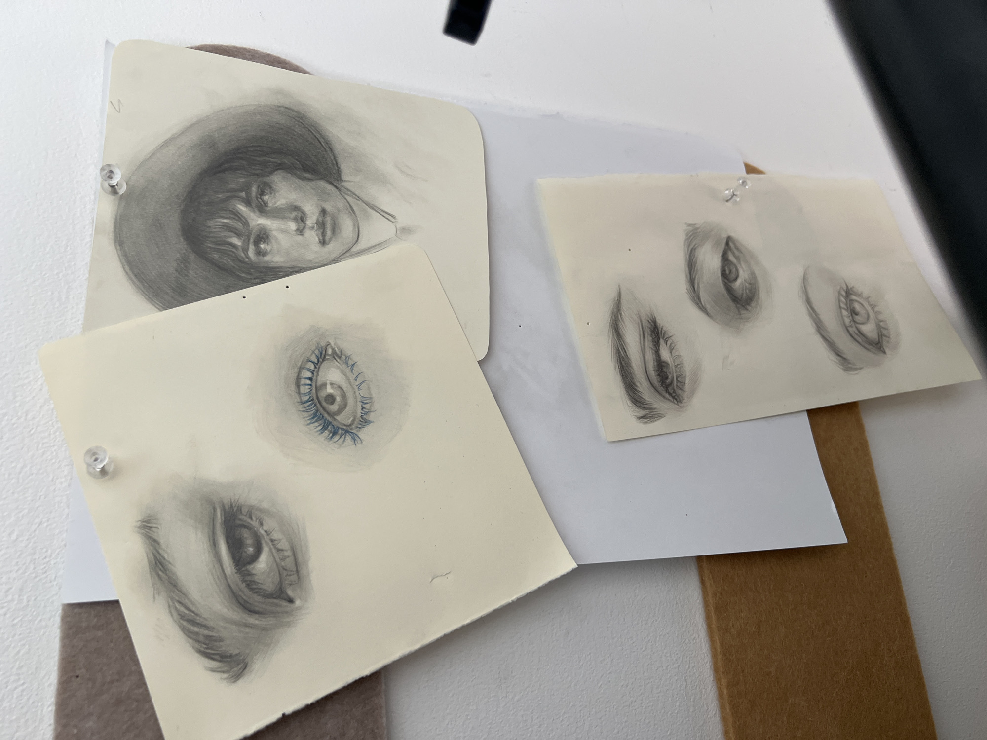 Art studio documentation with sketches, paintings, and creative materials
