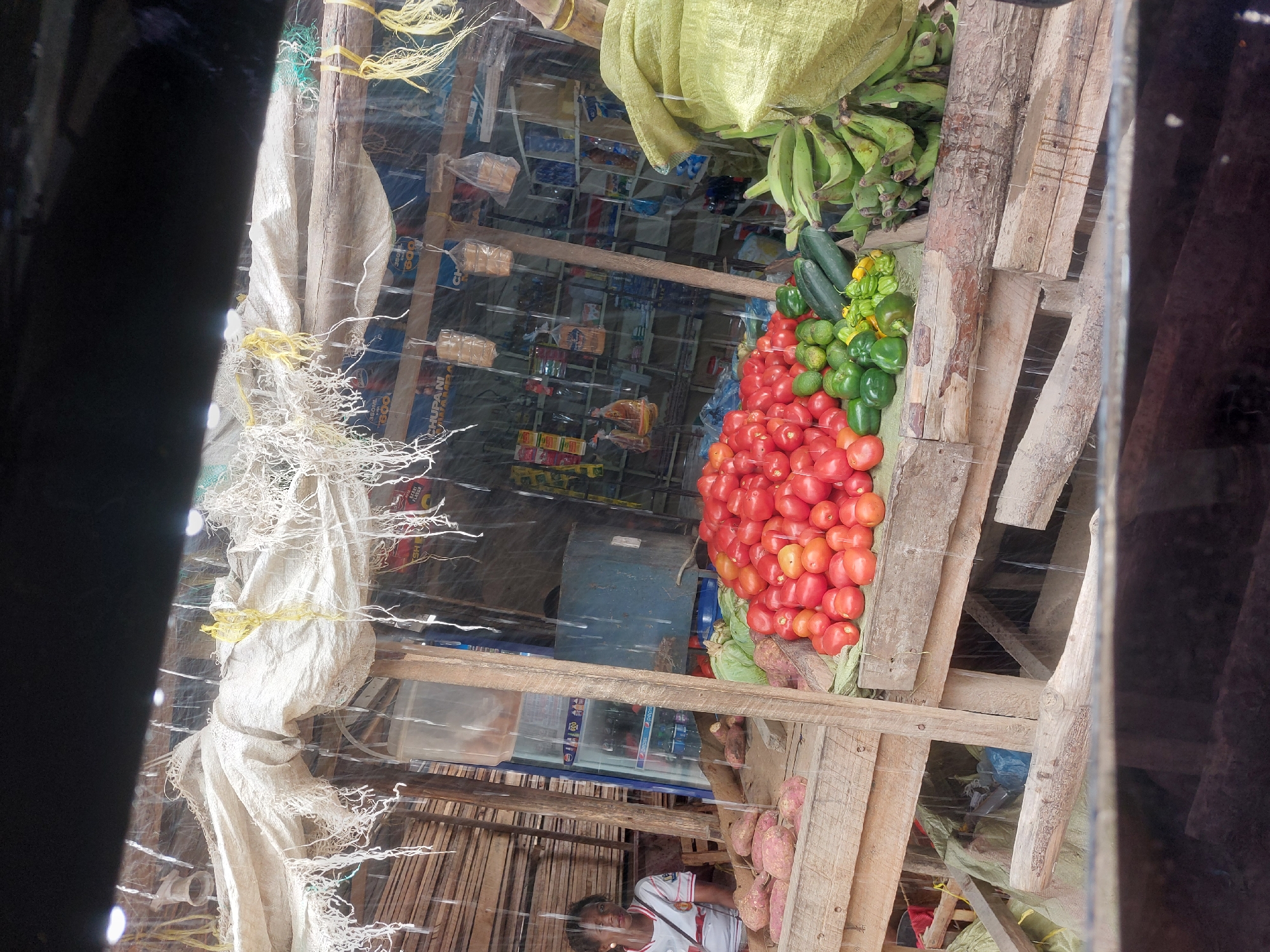 Roadside vendors serve customers during rainy afternoon in Dar es-Salaam