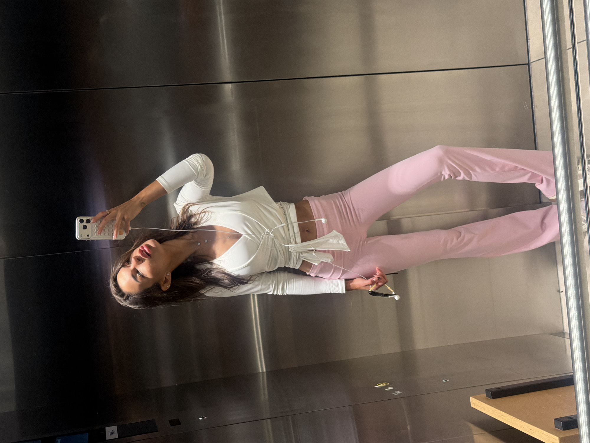 Elevator selfies in Amstelveen, white top and pink pants