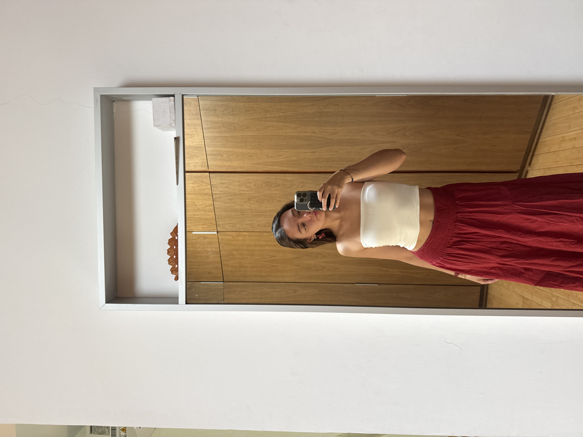 Woman takes mirror selfie in bedroom in Mexico