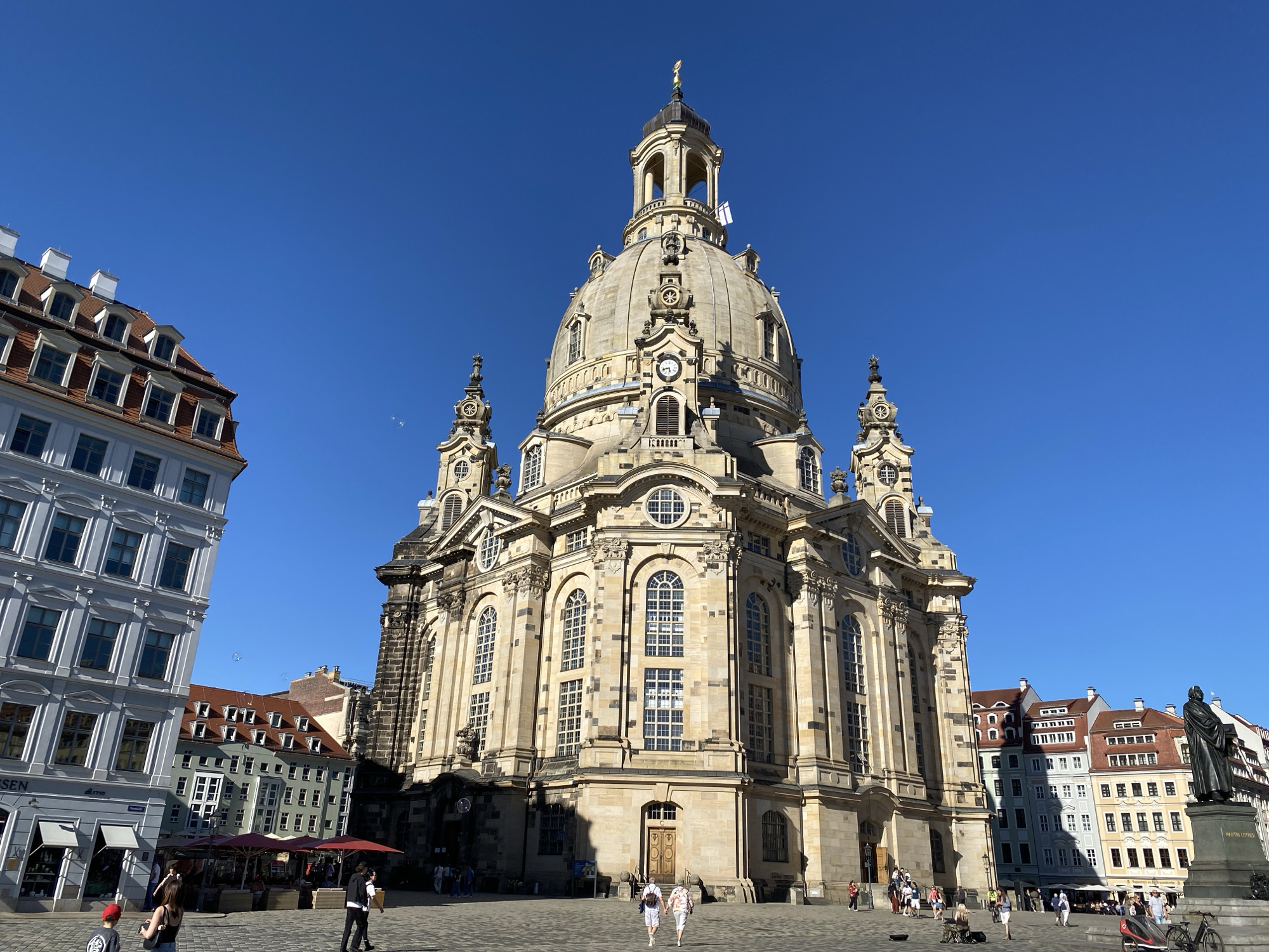 Tourist captures Dresden landmarks during afternoon walking tour
