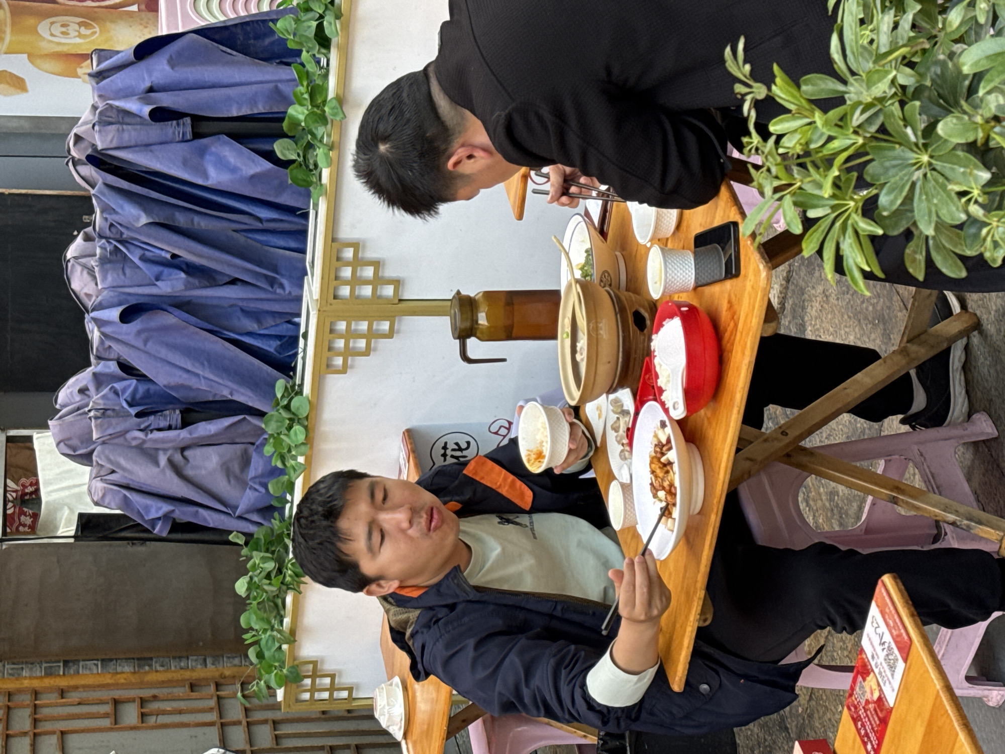 Two men share meal at table in Jinjiang District