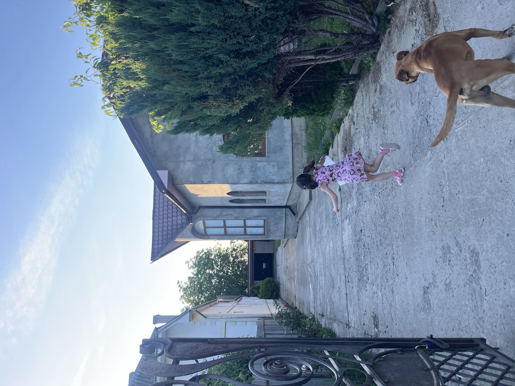 Child plays in Ukrainian neighborhood amid everyday domestic scenes