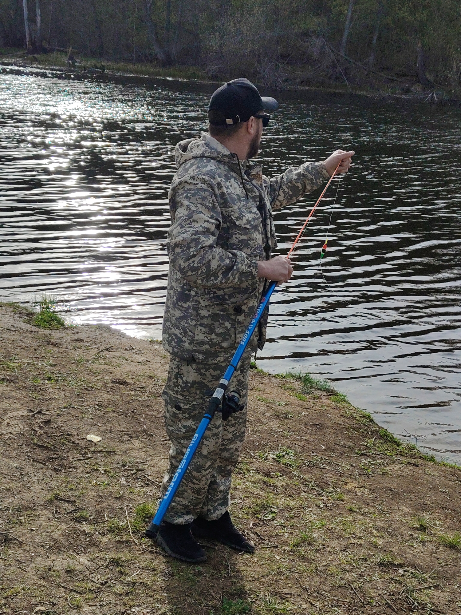 Anglers fish at waterfront location during midday hours