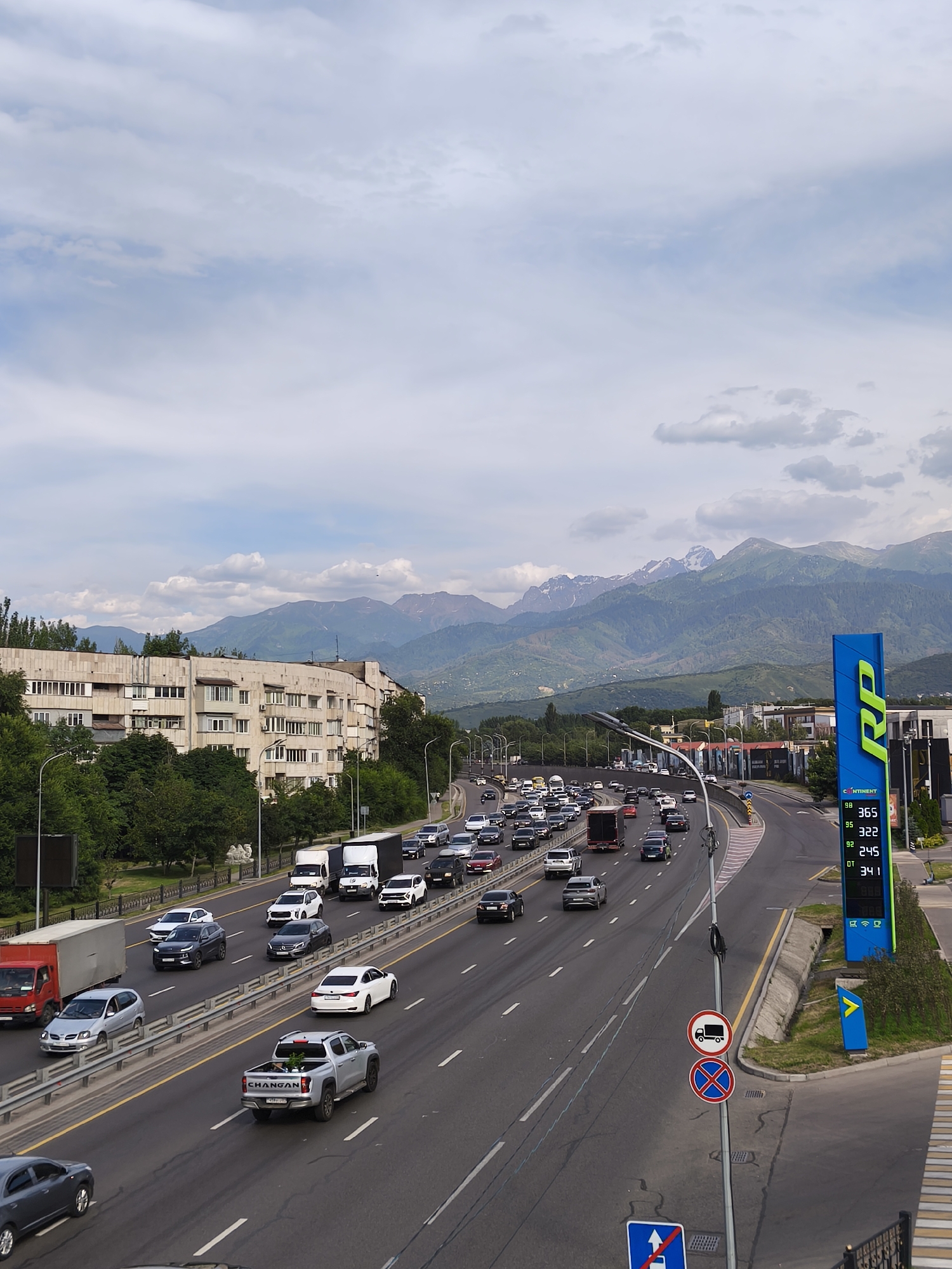 Almaty highway gridlock with mountain backdrop