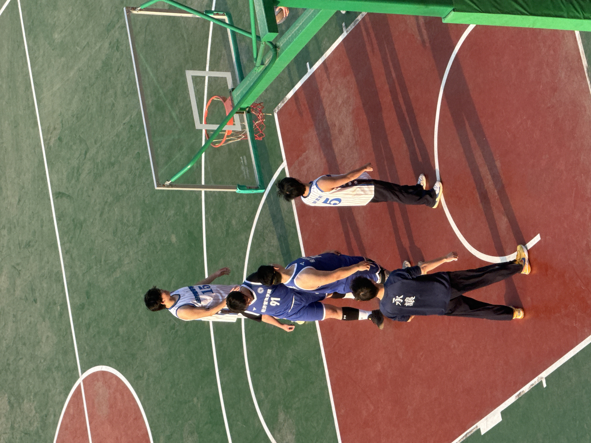 People lying on basketball court in Daxing District captured