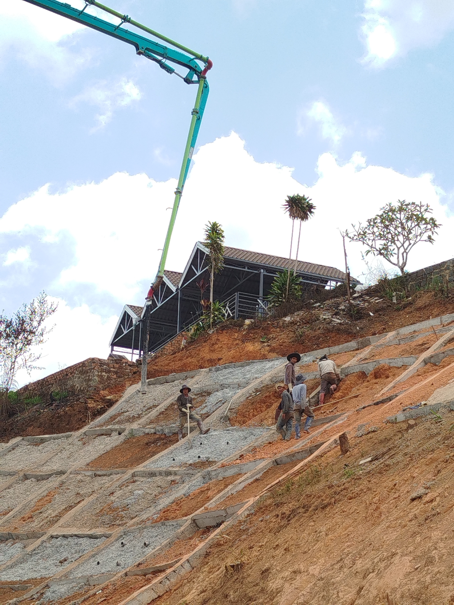 Construction crew works on terraced slope in Đa Thọ