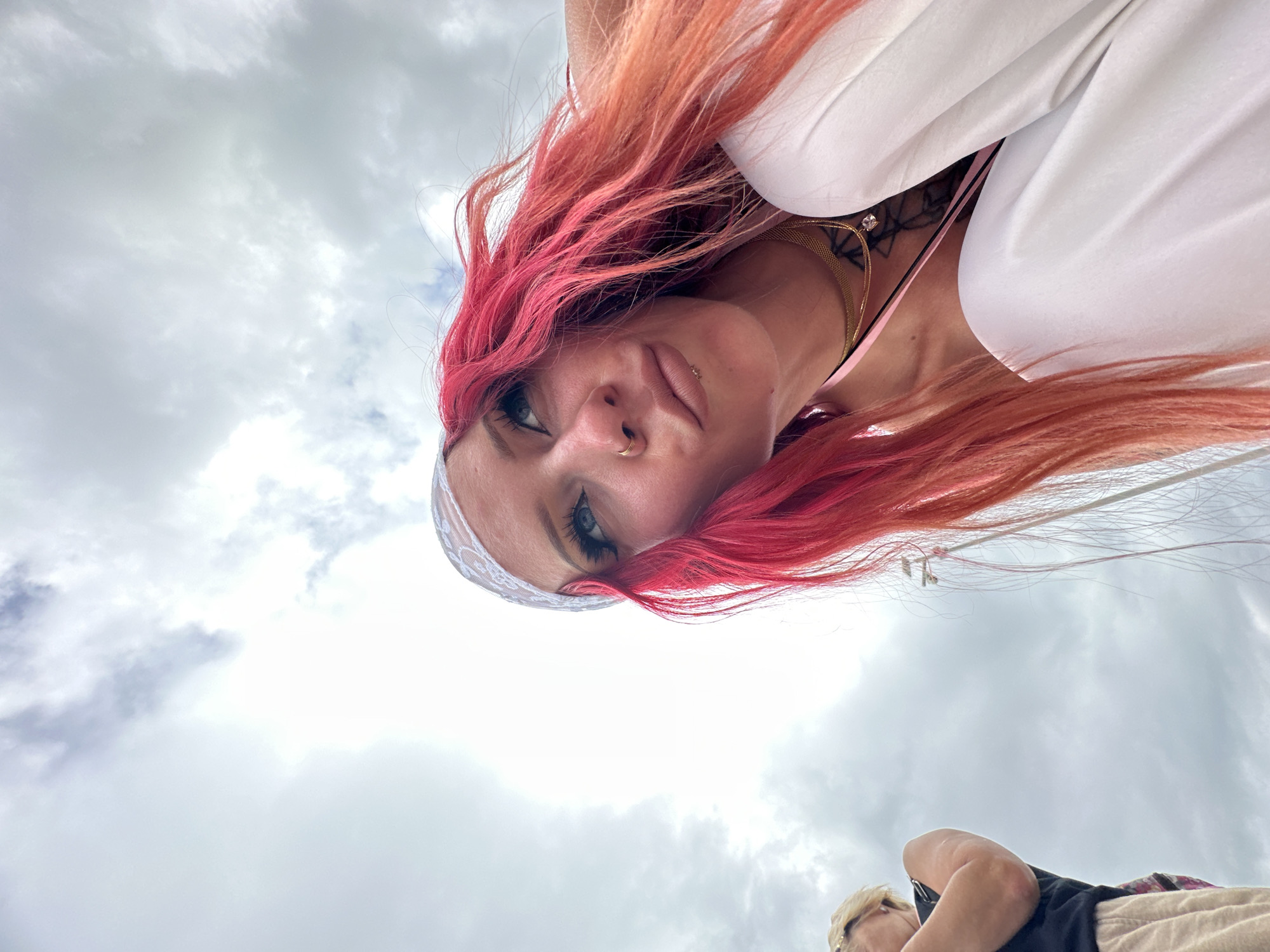 Pink-haired woman photographed in low-angle shots across Indonesian locations