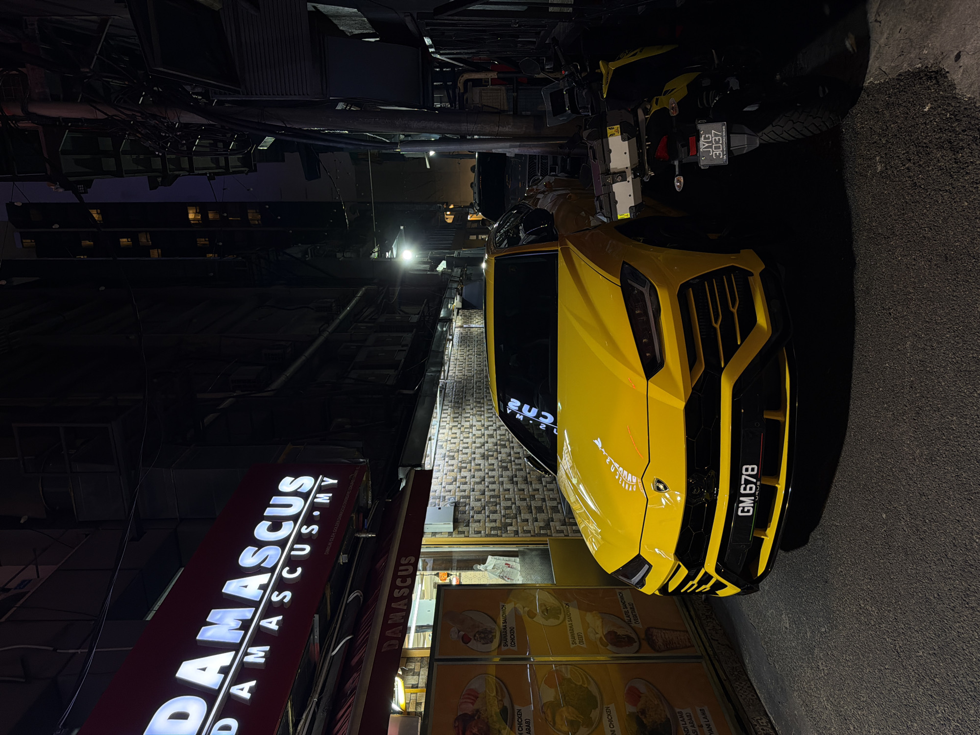 A busy KL night: street food, street dance, and a Lambo
