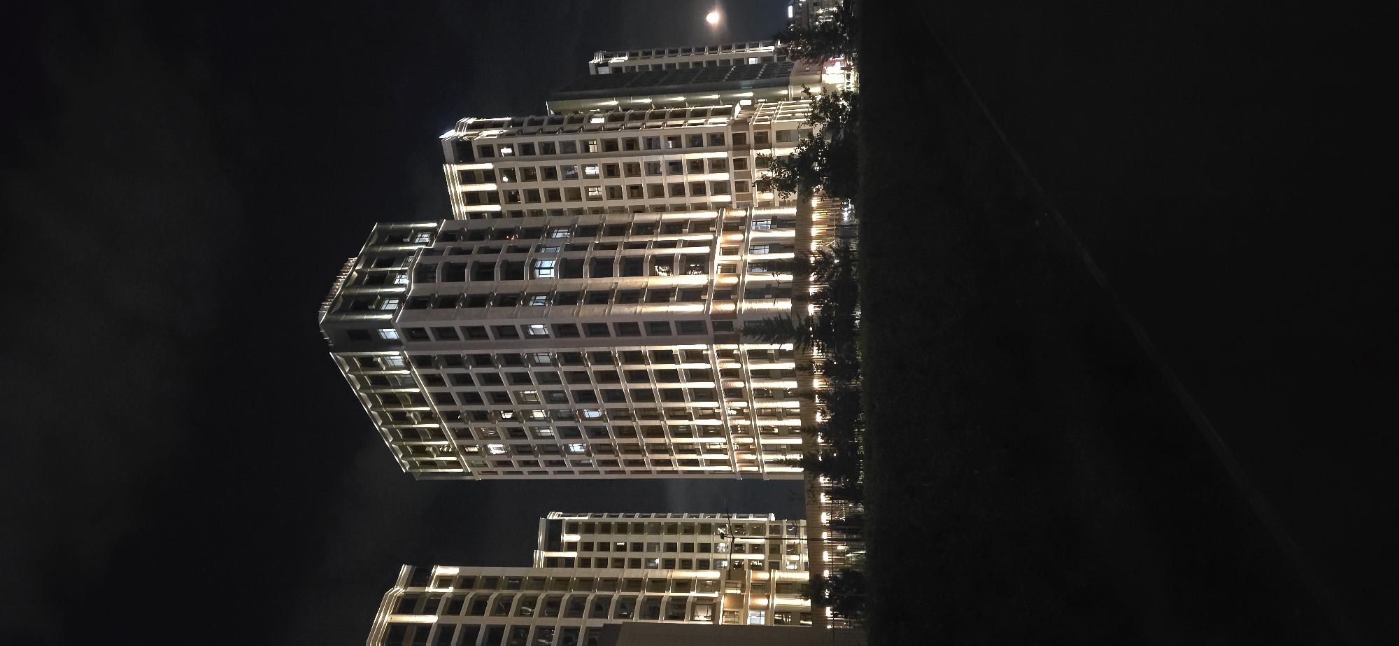 Illuminated residential towers line the Esil district at night