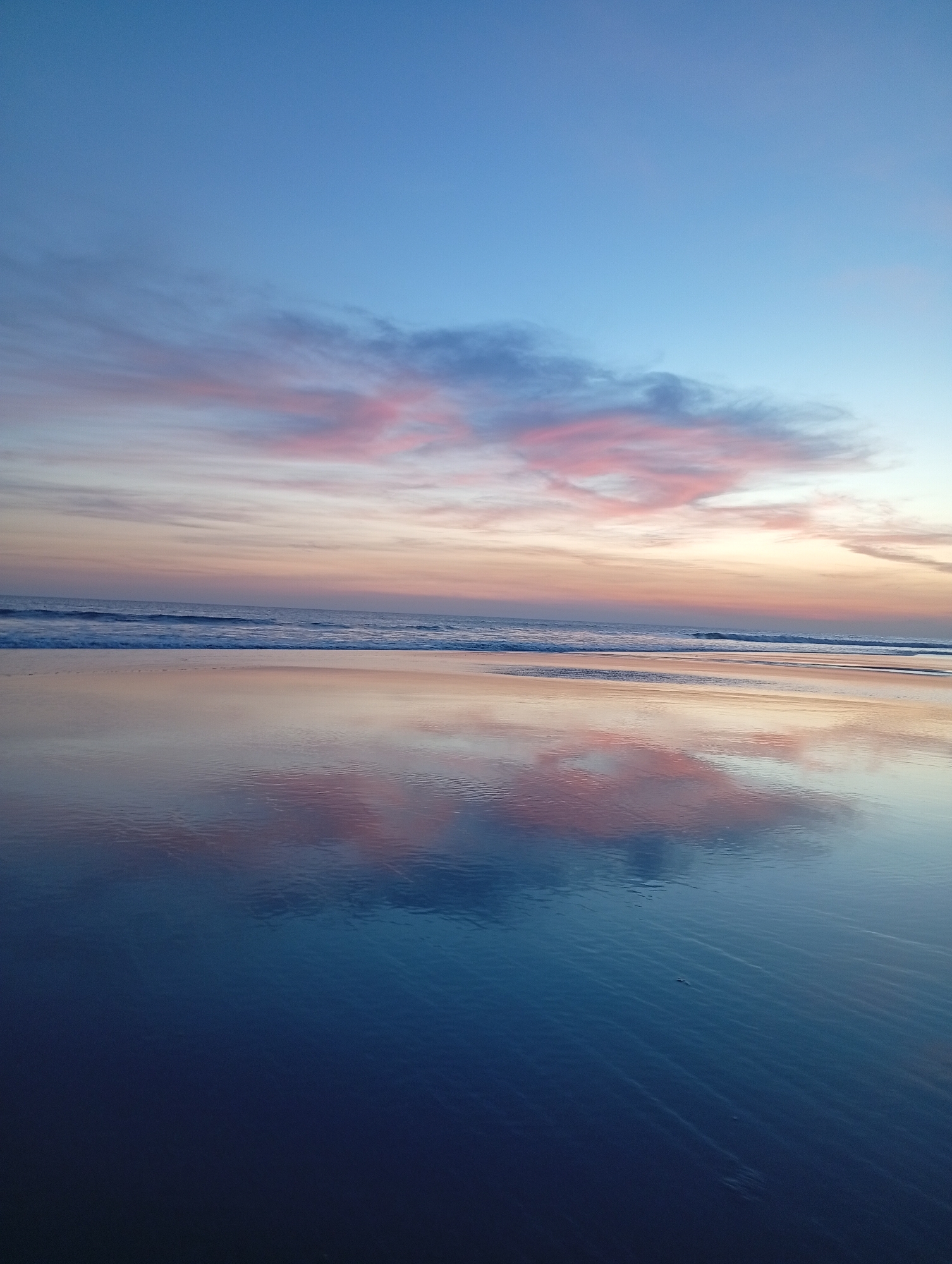 Sunset beach scene with silhouetted figures documented by witnesses
