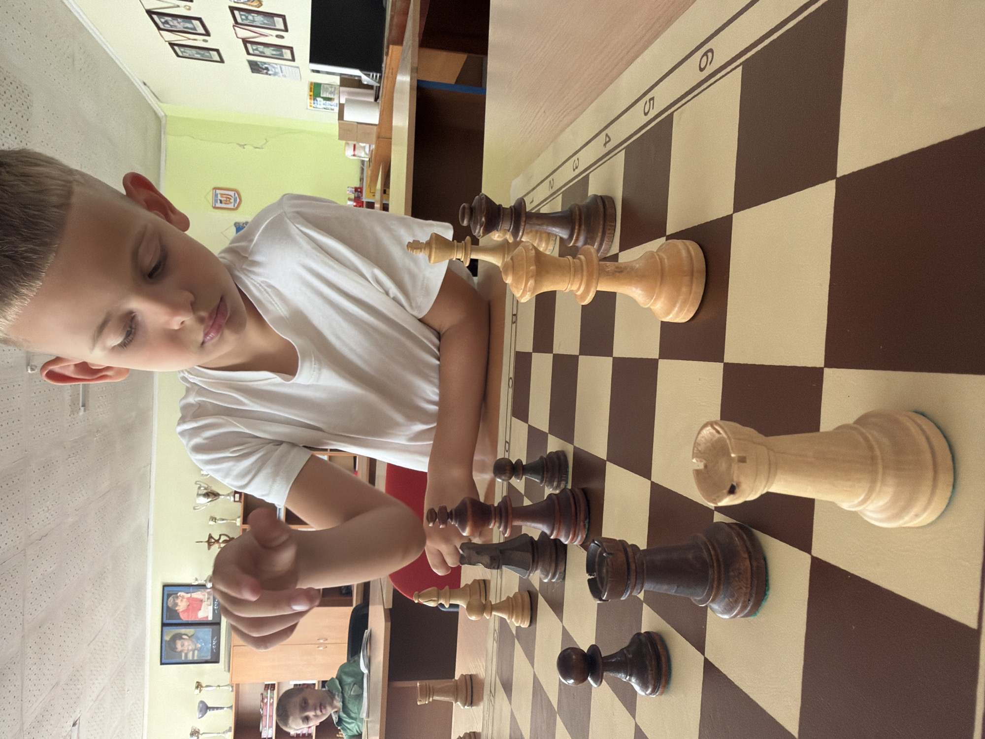 Chess session with focused board play and a tic-tac-toe cameo