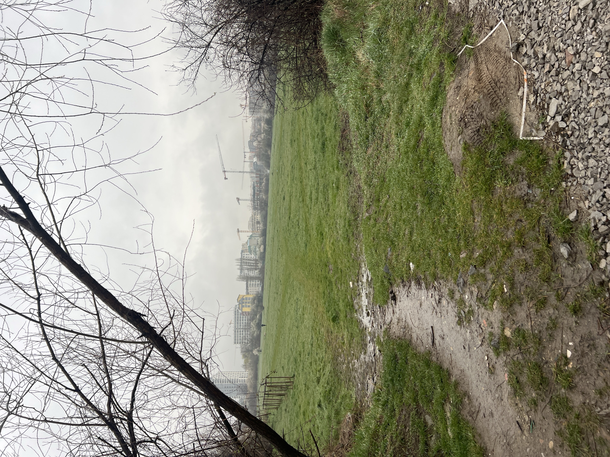 Muddy field with construction activity visible in Sofia