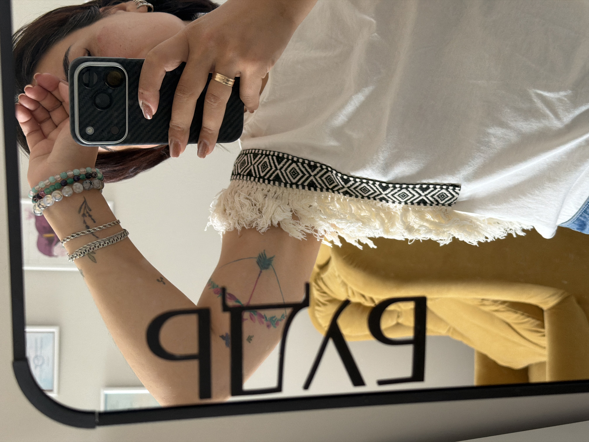 Mirror outfit selfies with a detail shot of floral tattoos