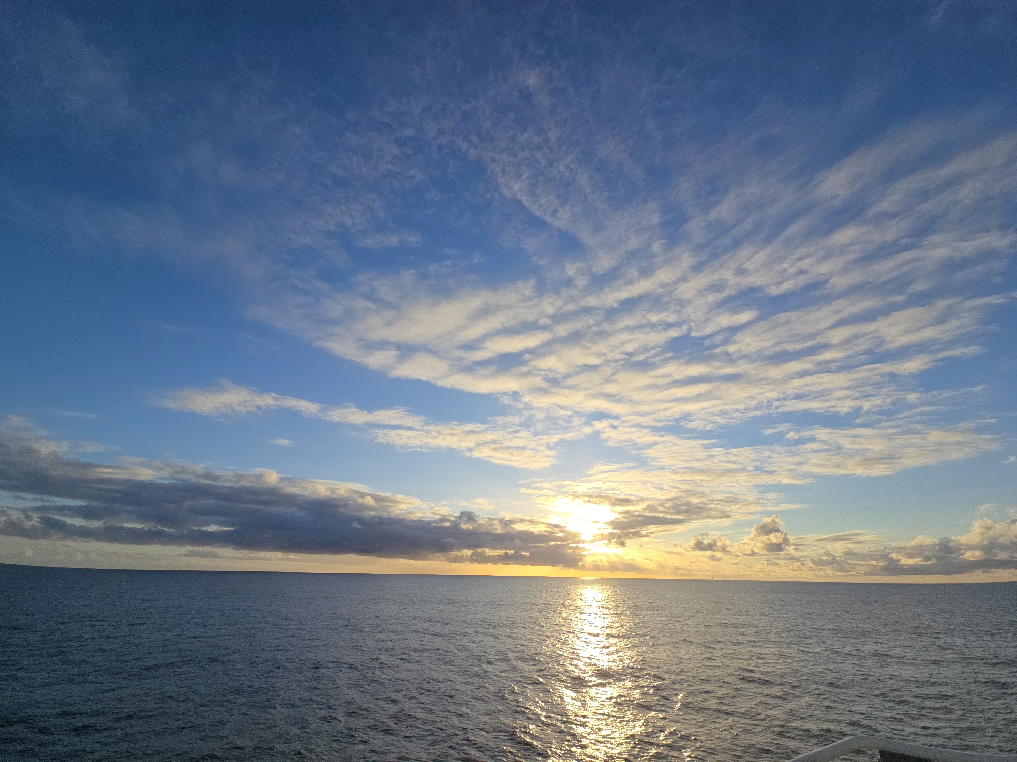 Sunset seascape documented with distant maritime structure visible