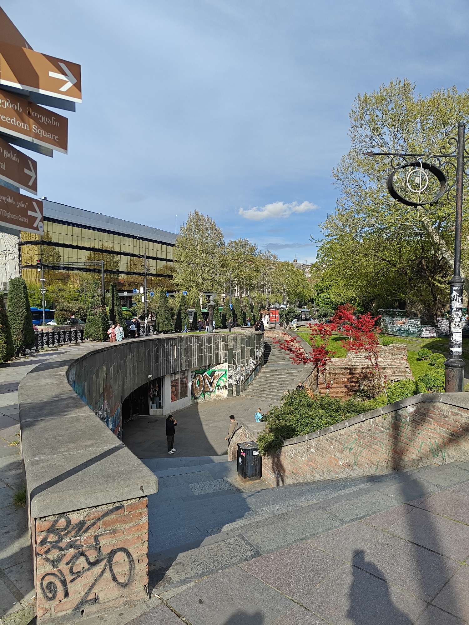 Tourist documents daytime scenes across historic Tbilisi neighborhoods