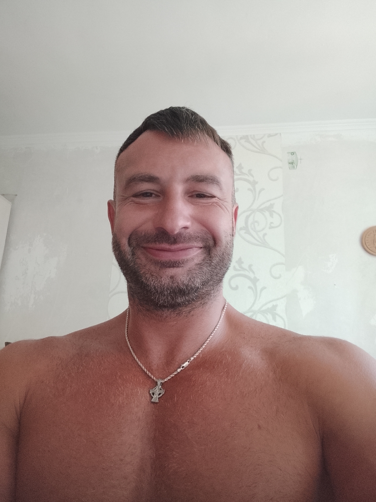 Series of selfies at home in Chișinău, cross pendant and wallpaper backdrop