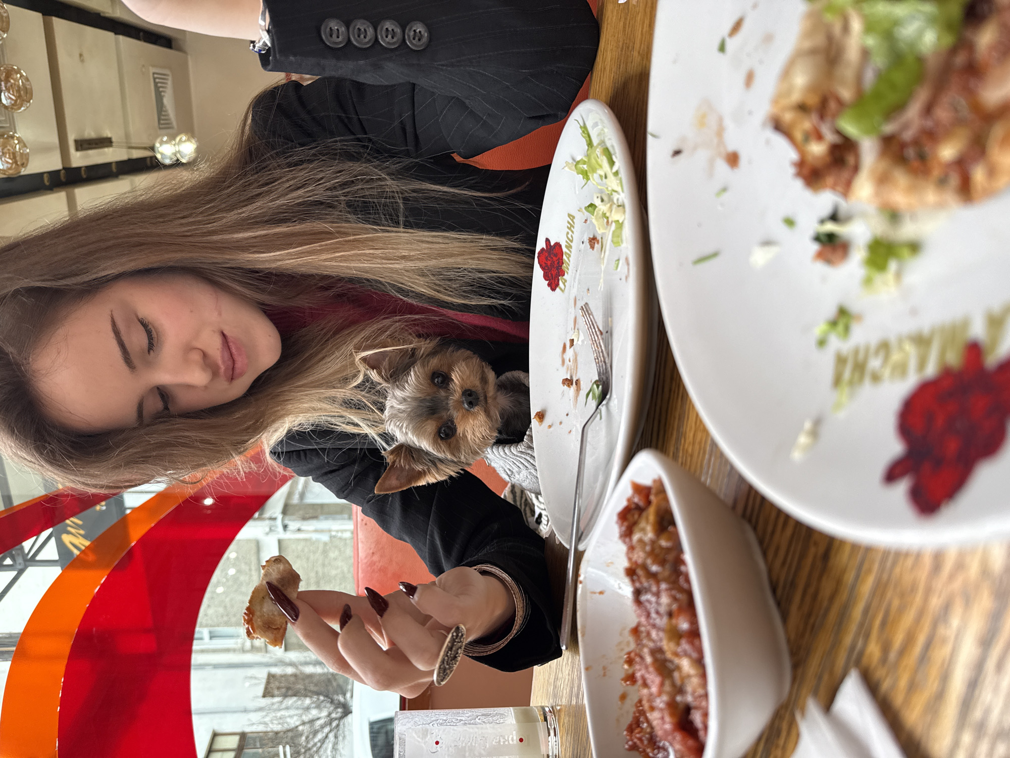 Woman dines with dog at Sofia restaurant