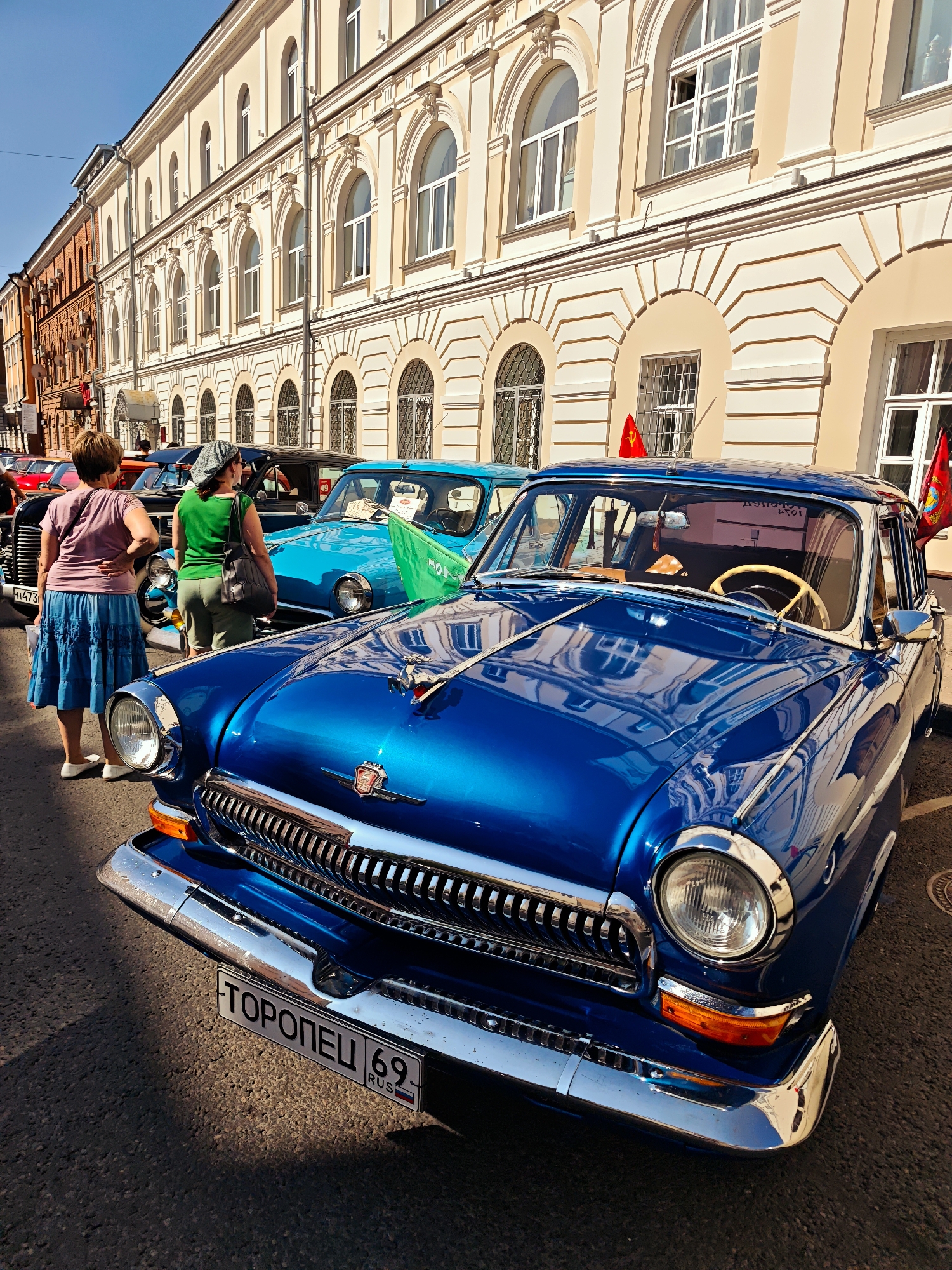 Vintage car show fills sunny Tver street on a summer morning