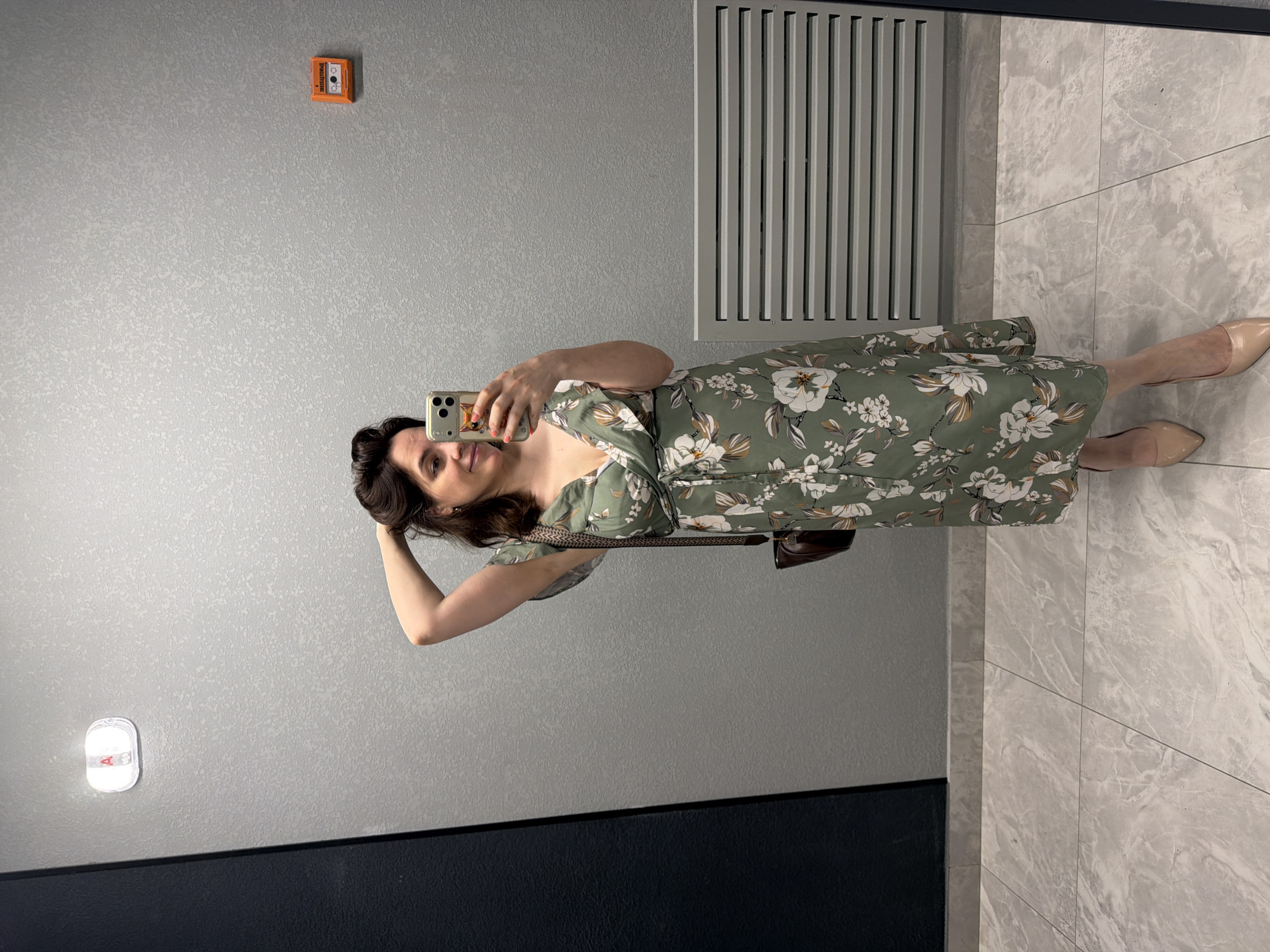 Mirror selfie in a Perm restroom, green floral dress