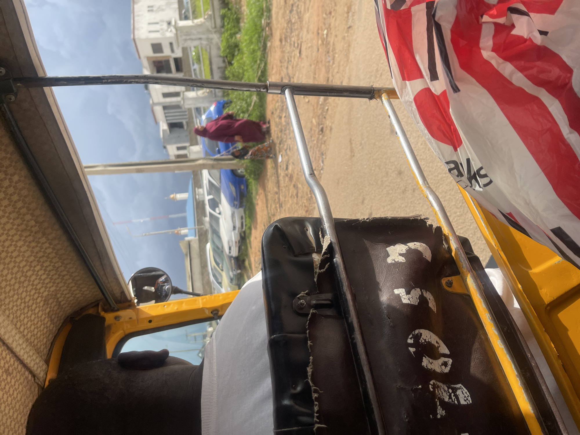 Street traffic and roadside commerce on a Jos, Nigeria thoroughfare