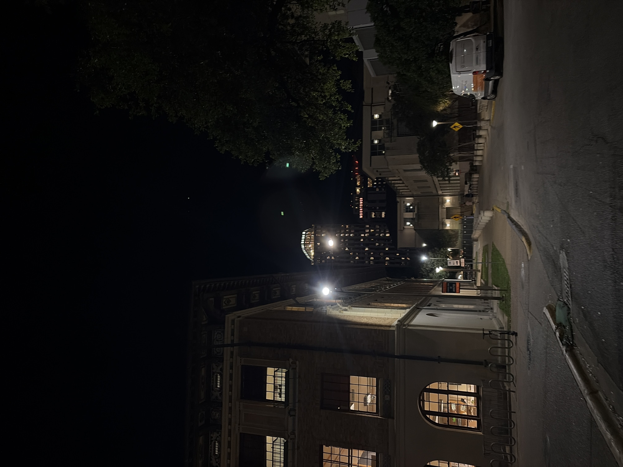 Illuminated academic building photographed during Austin night