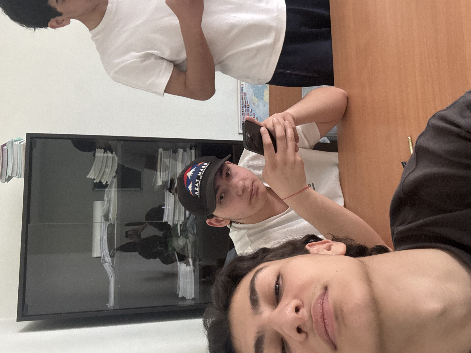 Person using smartphone captured from multiple angles in Yerevan classroom