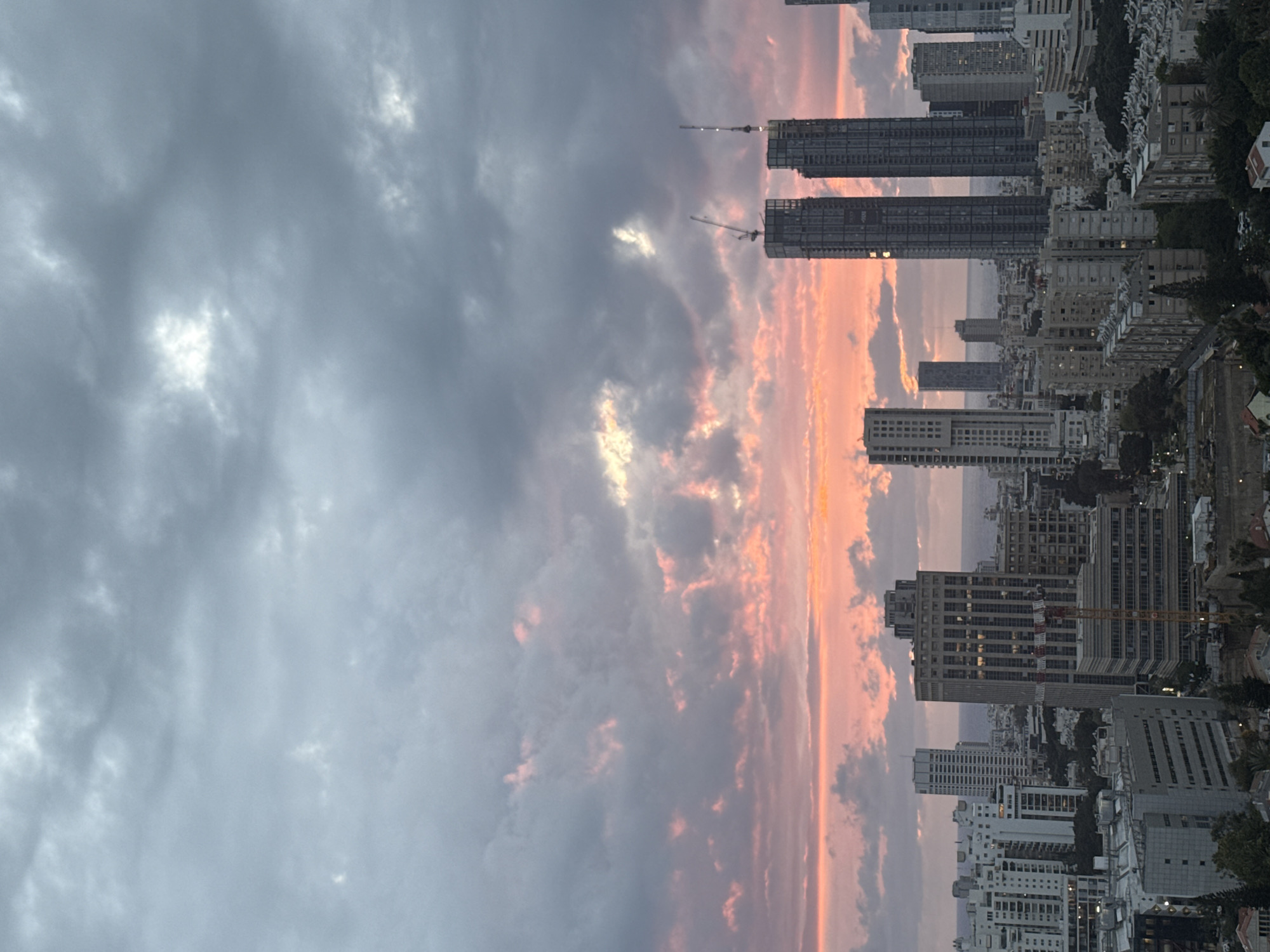 Tel Aviv skyline photographed at dusk with construction cranes