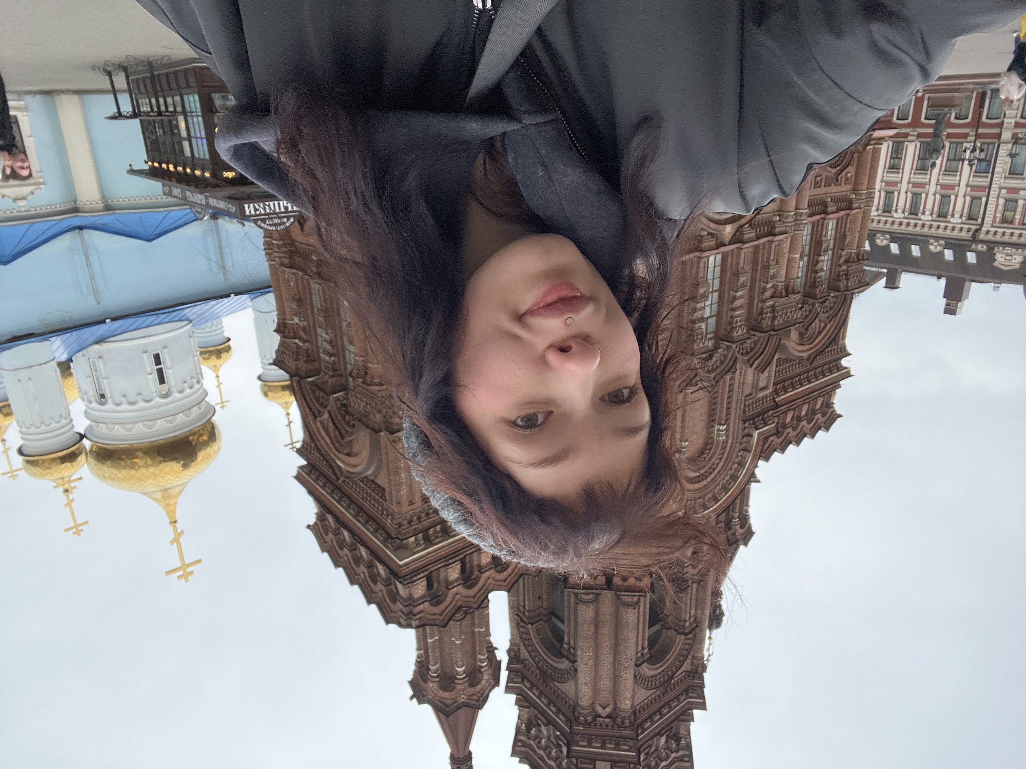 Woman takes upside-down selfie near historic building in Kazan
