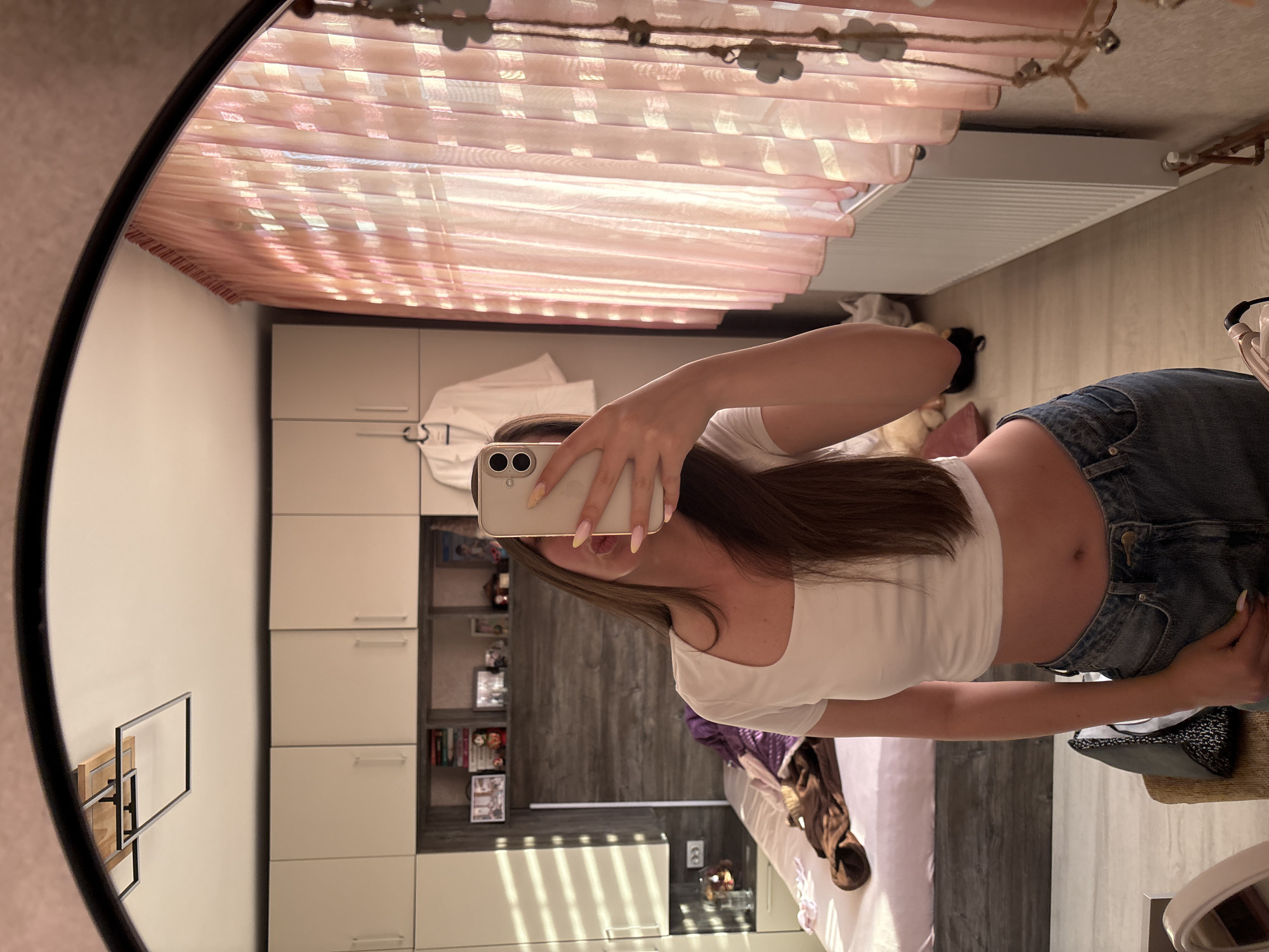 Woman takes mirror selfies in bedroom, Bulgarovo Bulgaria
