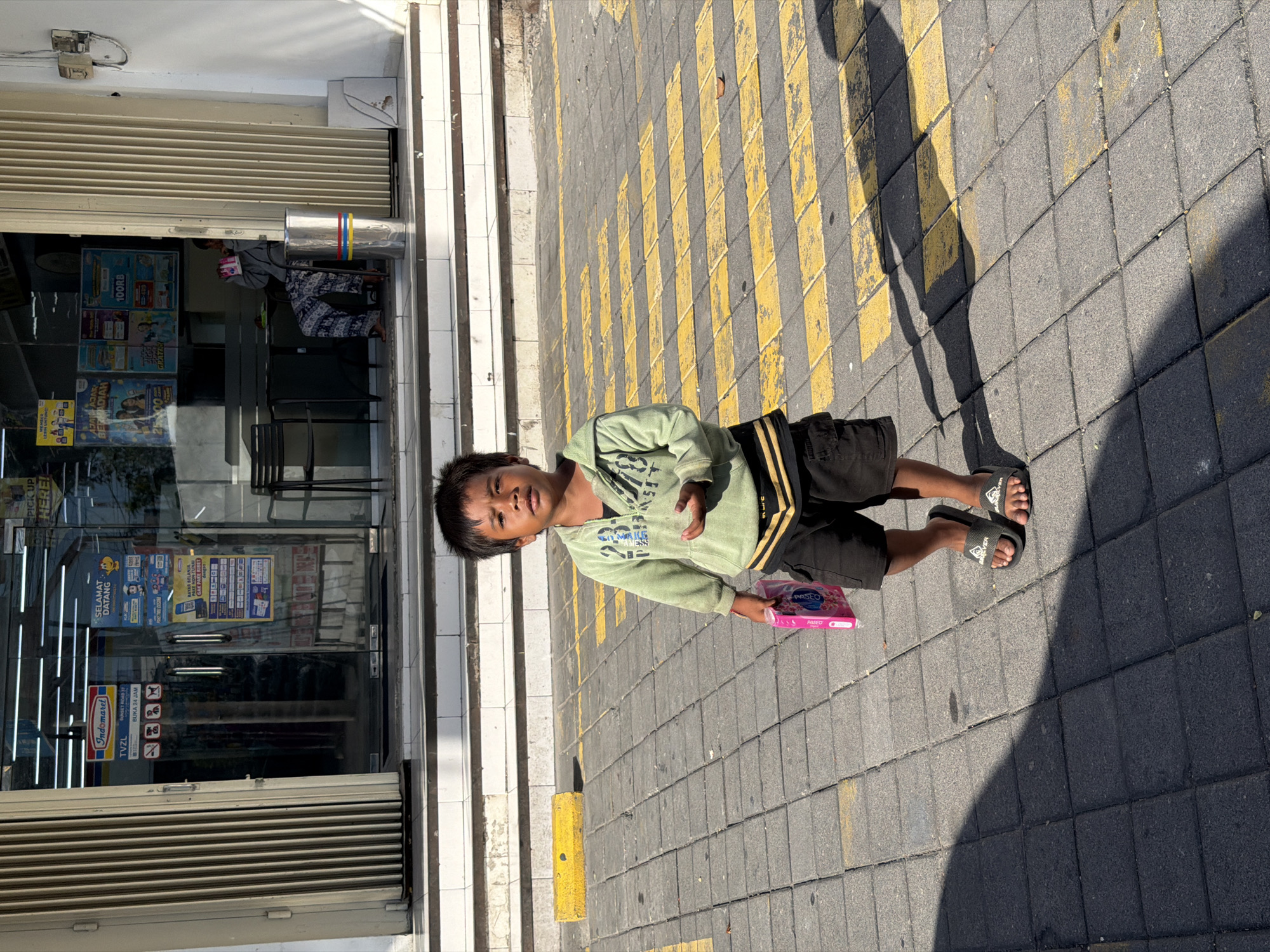 Morning street and storefront activity in Kuta, Bali