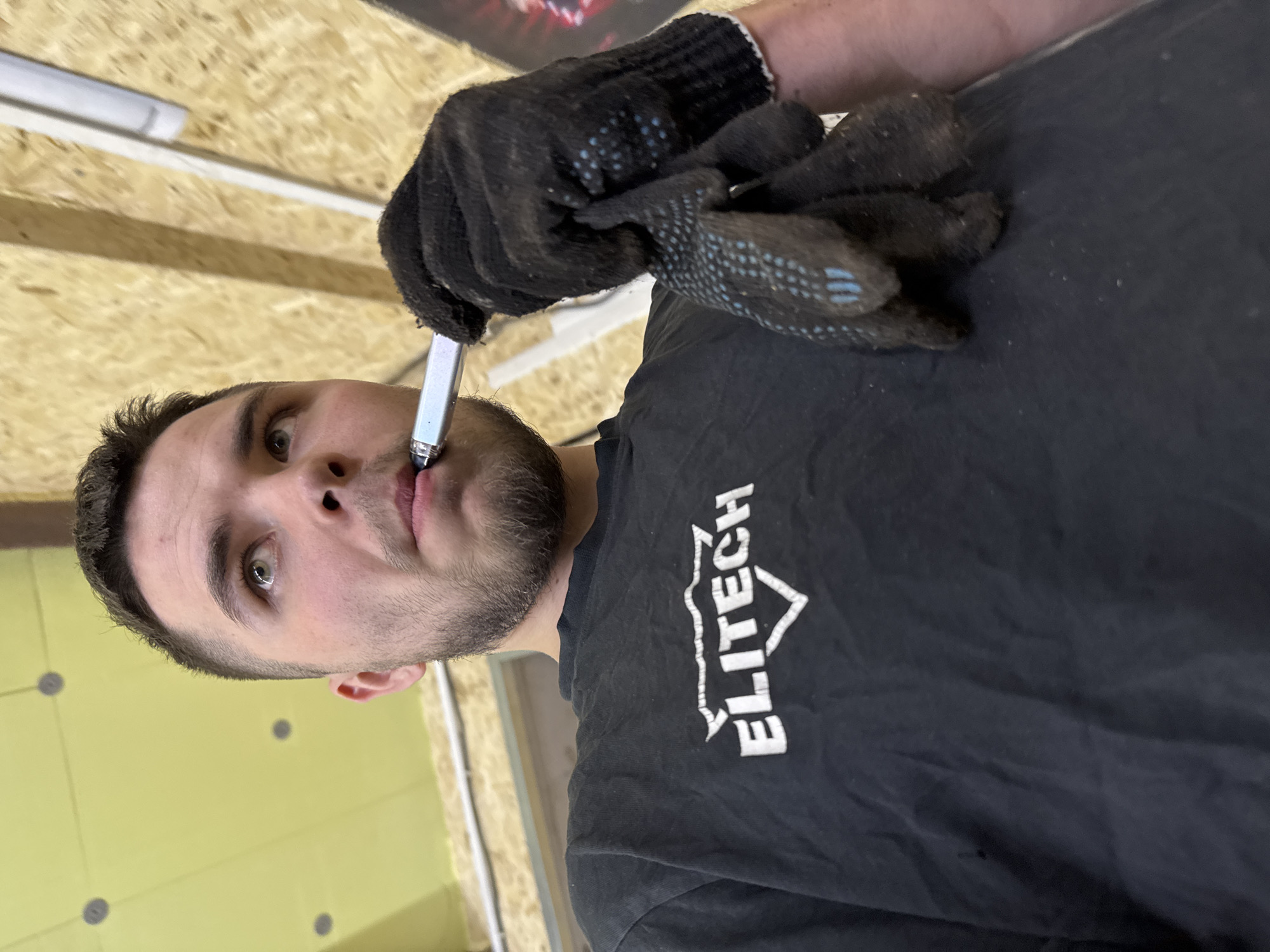 Mechanic repairs sedan in Perm garage workshop