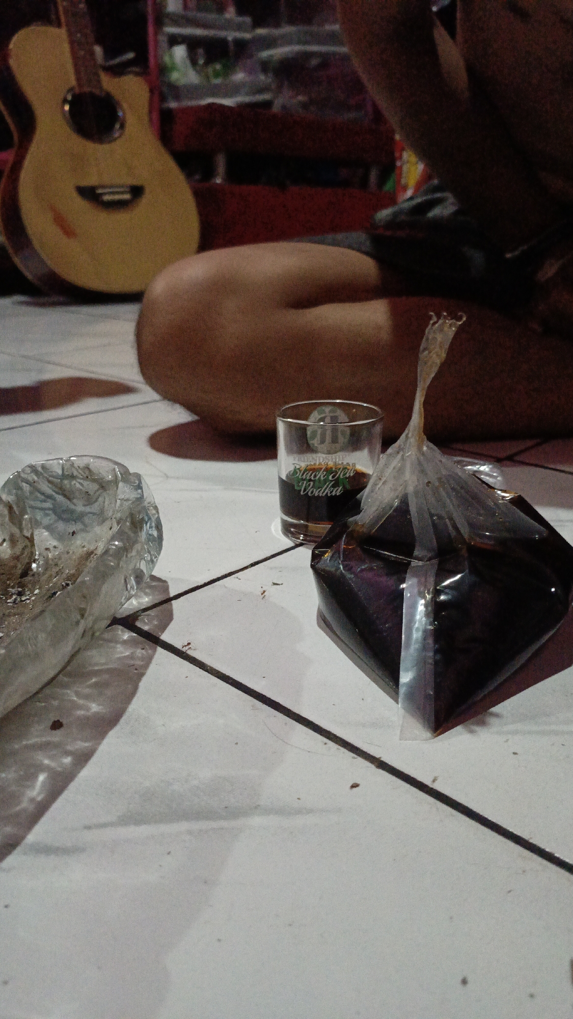 Young men vaping, relaxing indoors in Depok residence