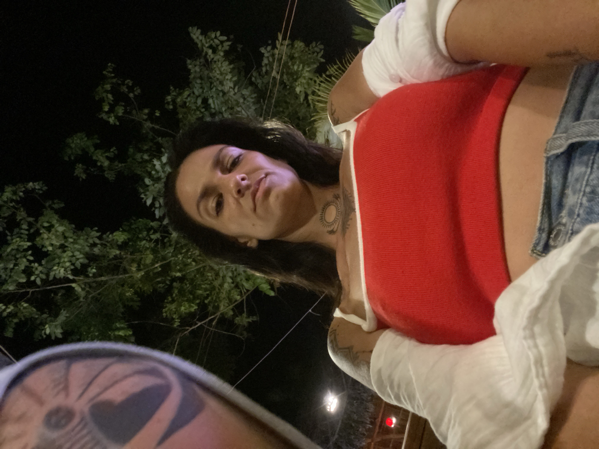 Woman takes selfies at outdoor restaurant in Vietnam