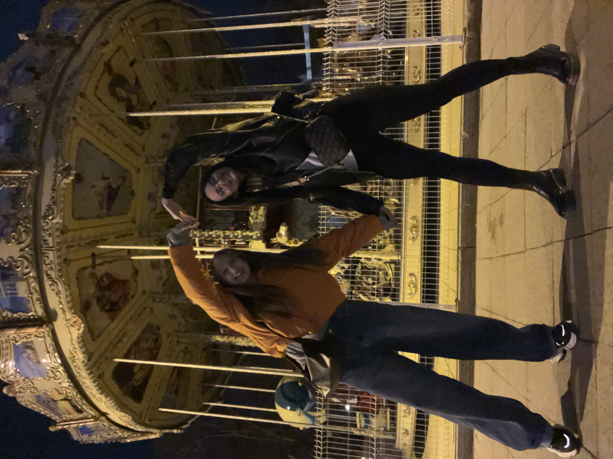 Two women explore illuminated Tyumen attractions during evening outing