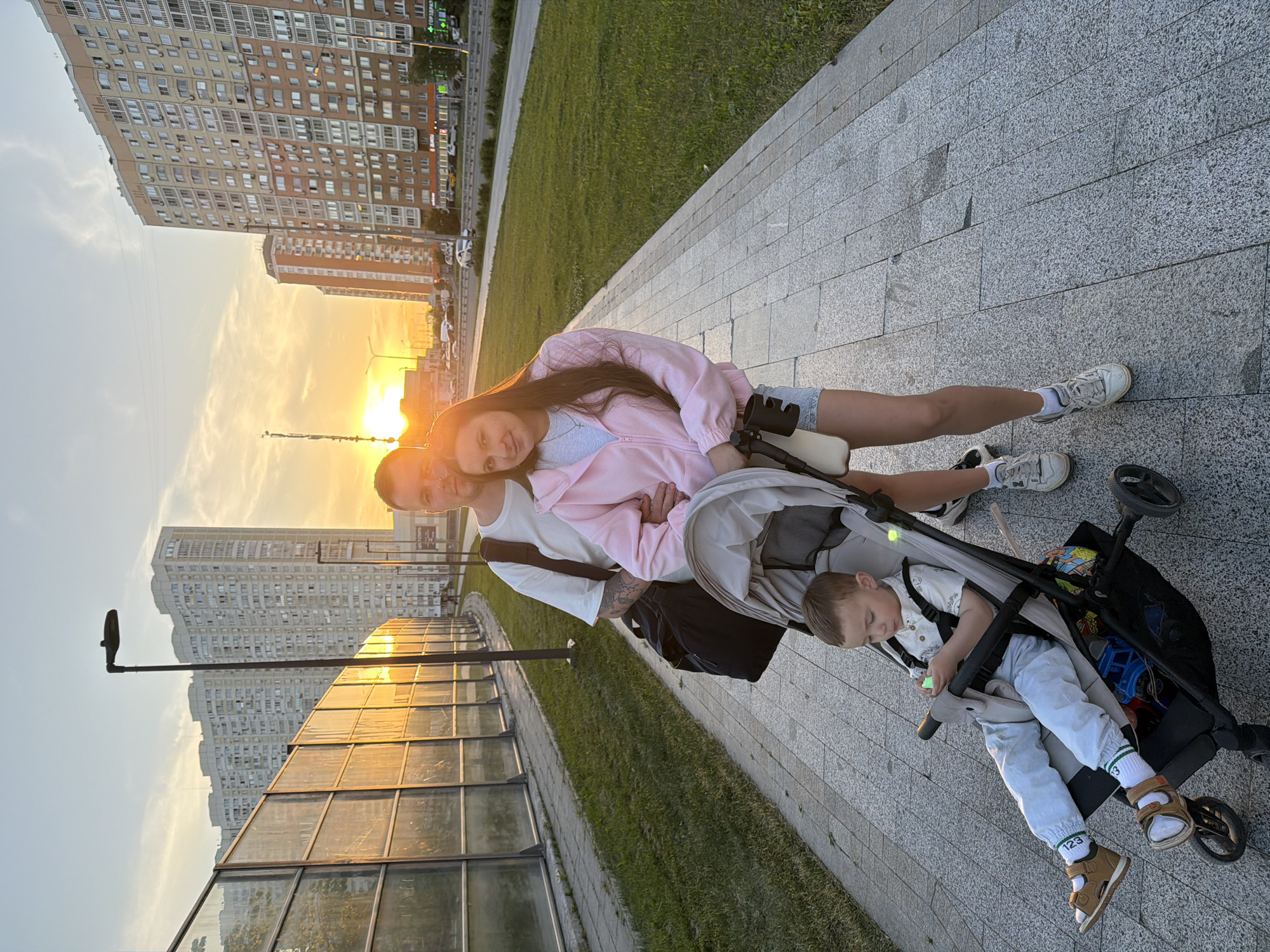 Family strolls Moscow streets as aircraft passes overhead