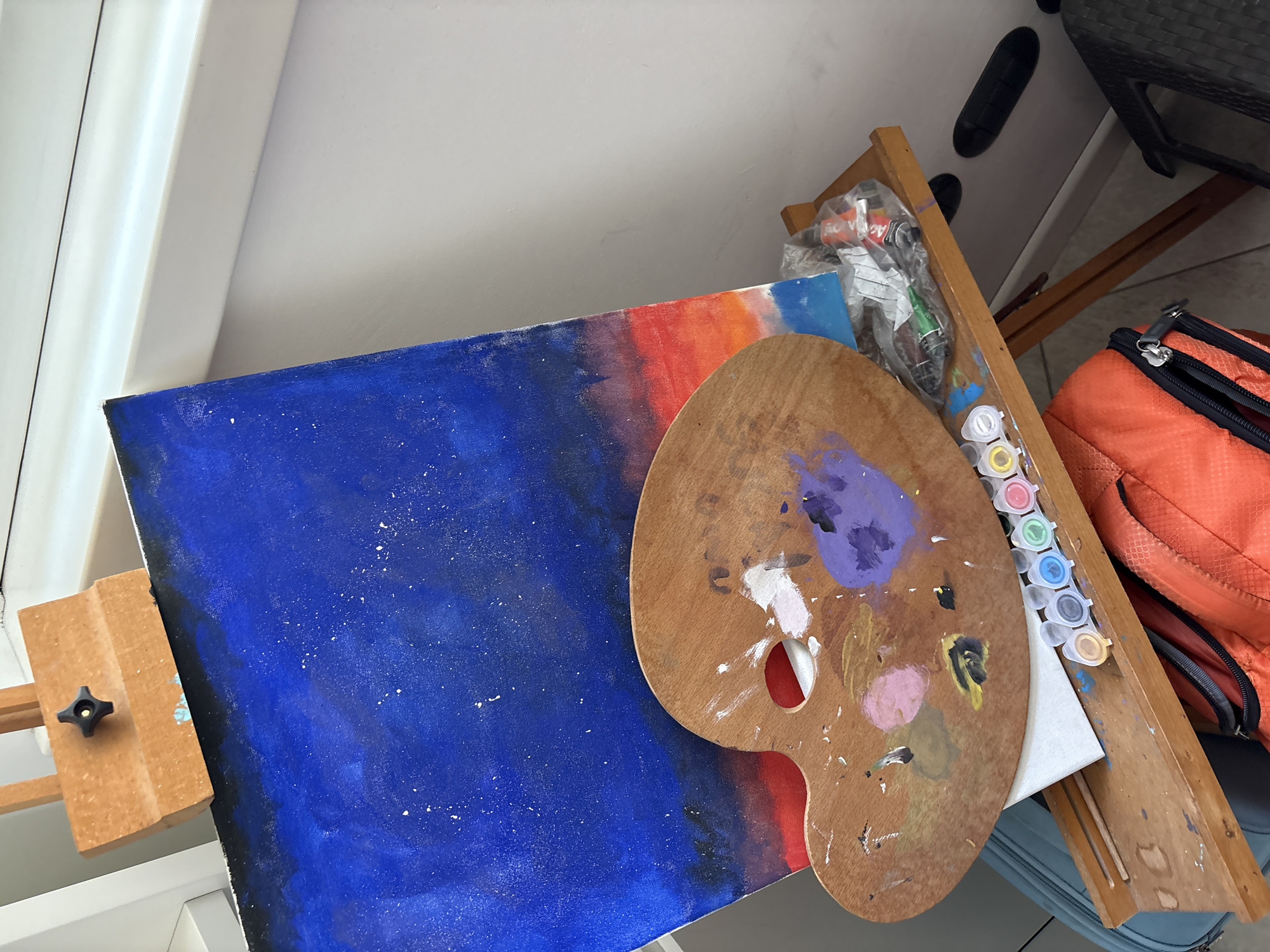Artist's workspace documented in Milan showing paintings and supplies