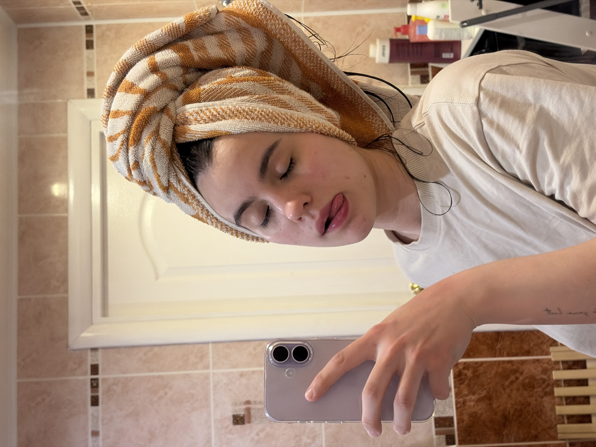 Woman takes bathroom selfies with cat nearby in Chaikovsky