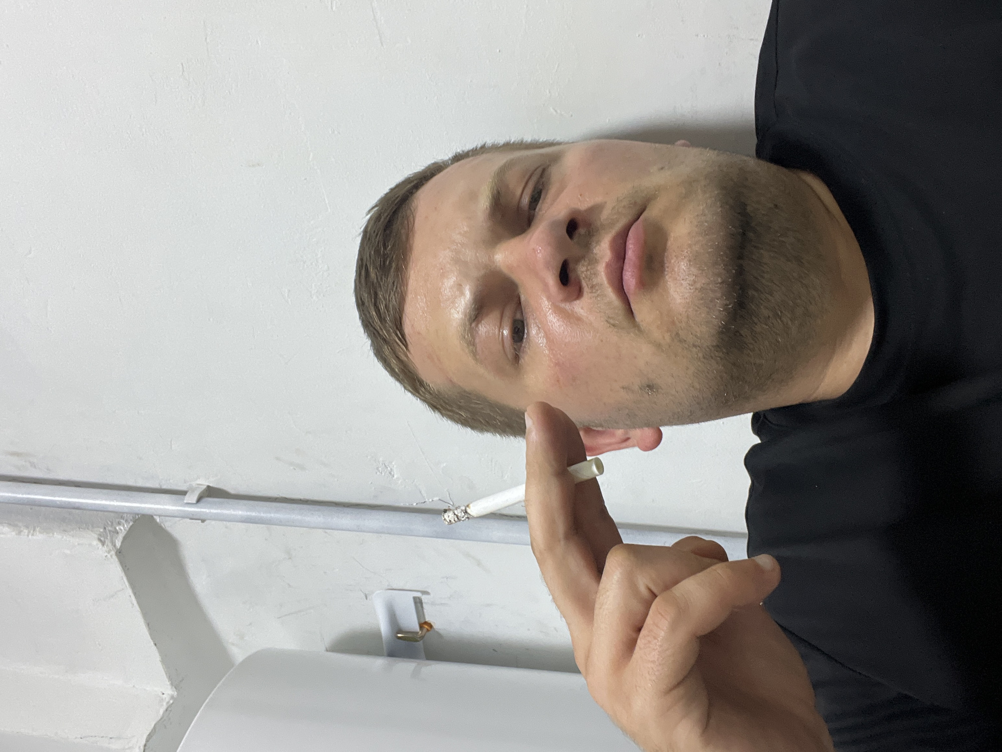 Lit cigarette held close-up in Baku