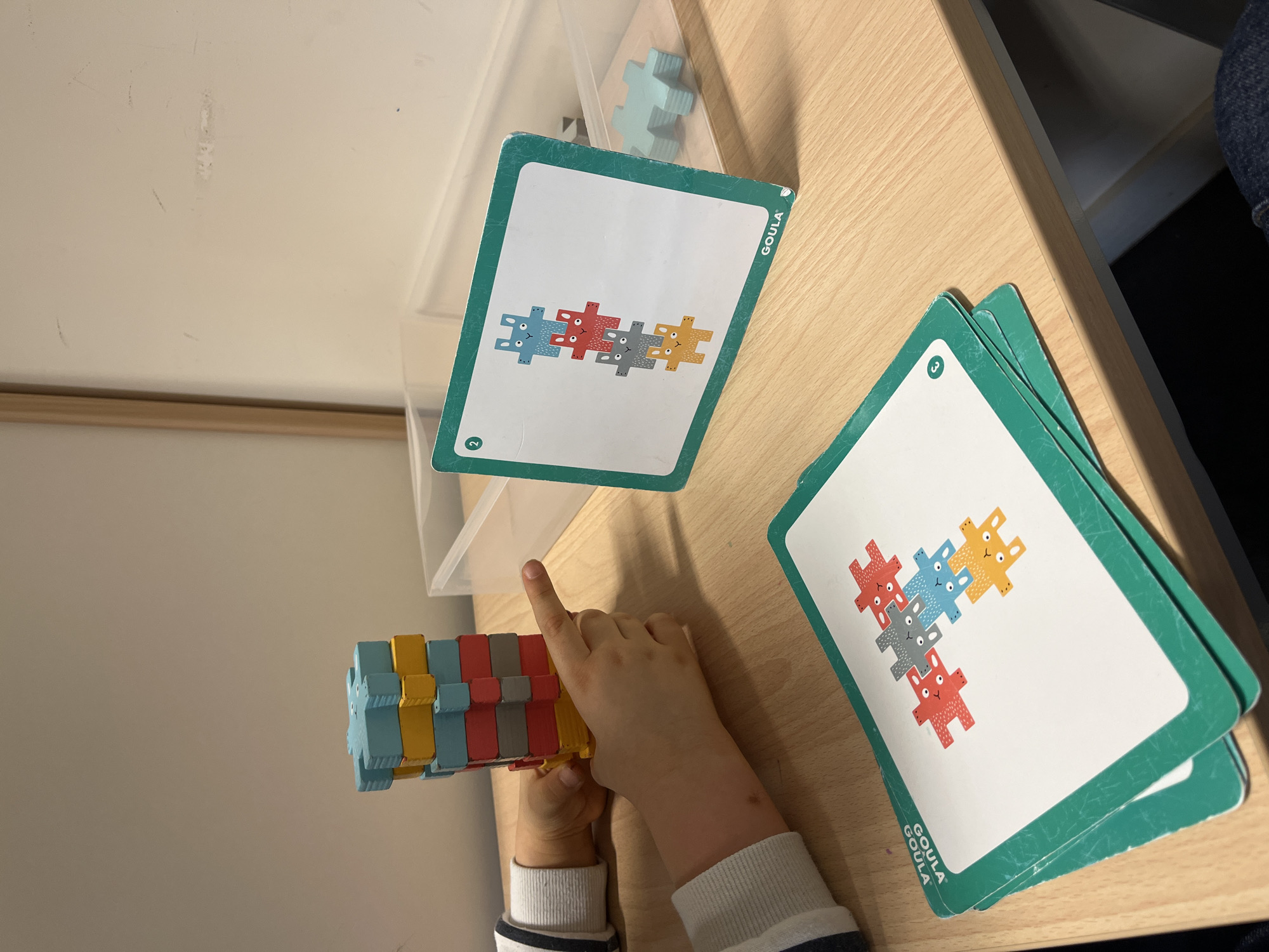 Child plays with wooden puzzle in La Fouillouse