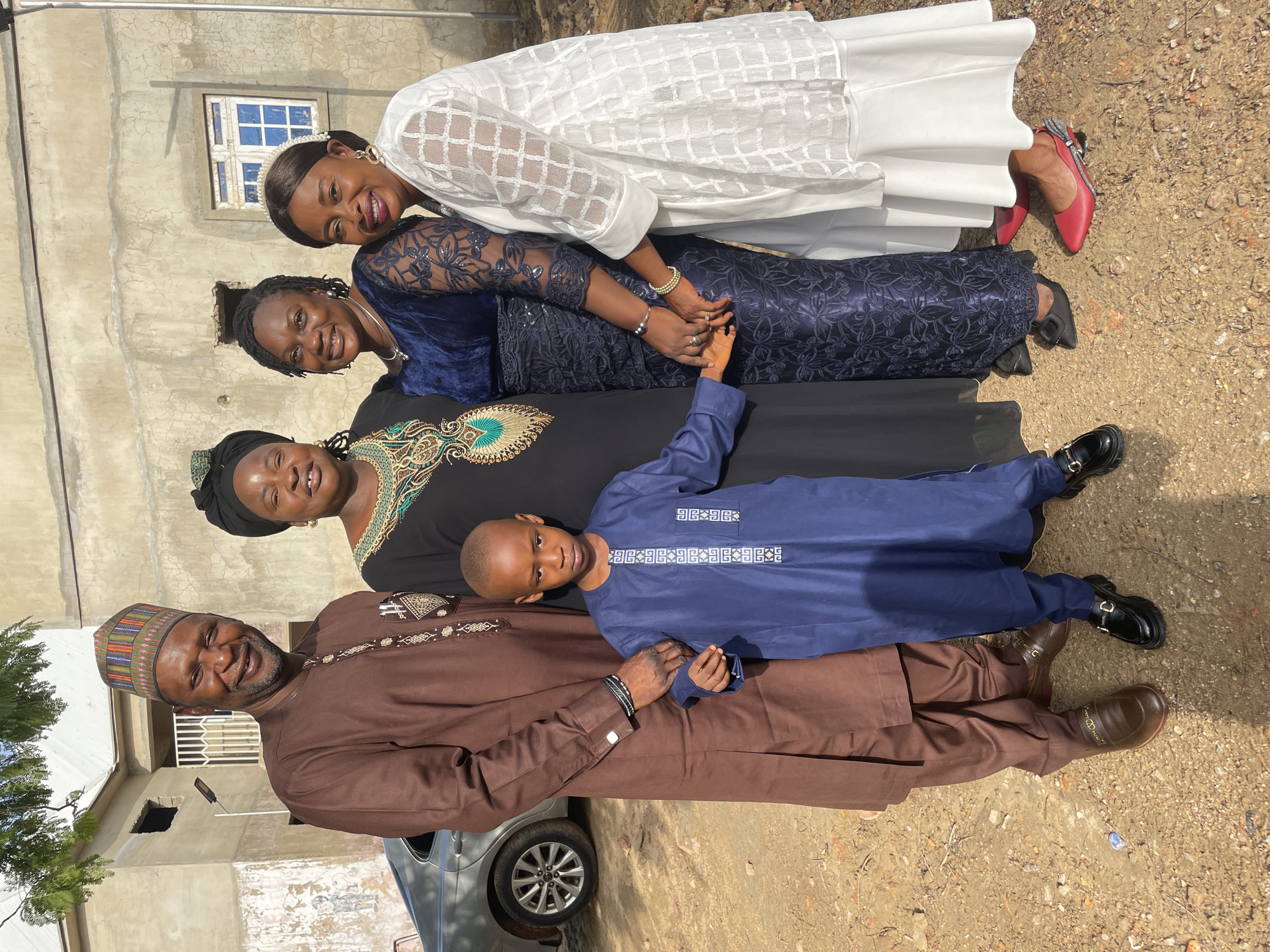 Women and boy pose for photos in Akwanga, Nigeria