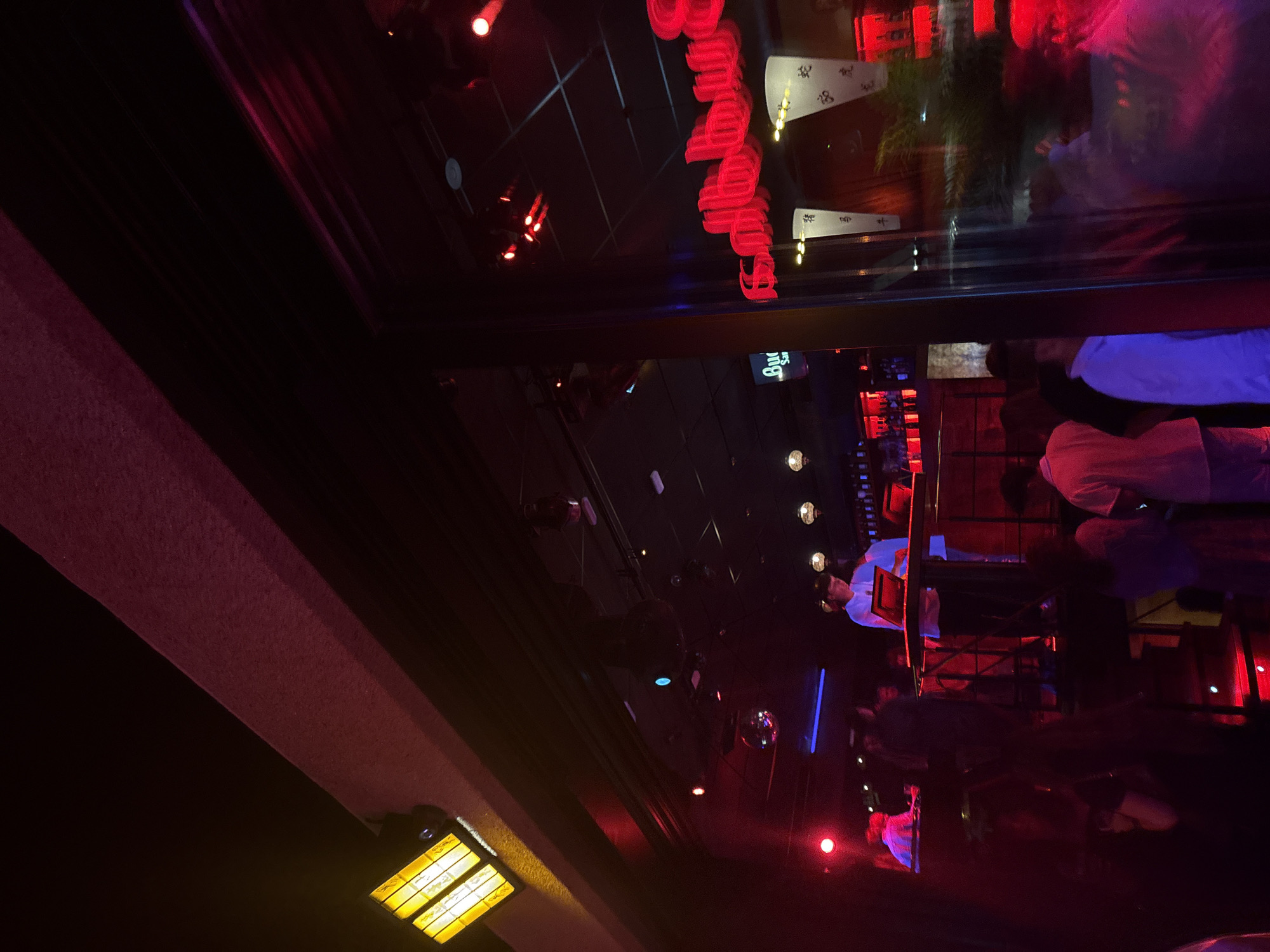 Packed nightclub in Sanxenxo, DJ set under red lights