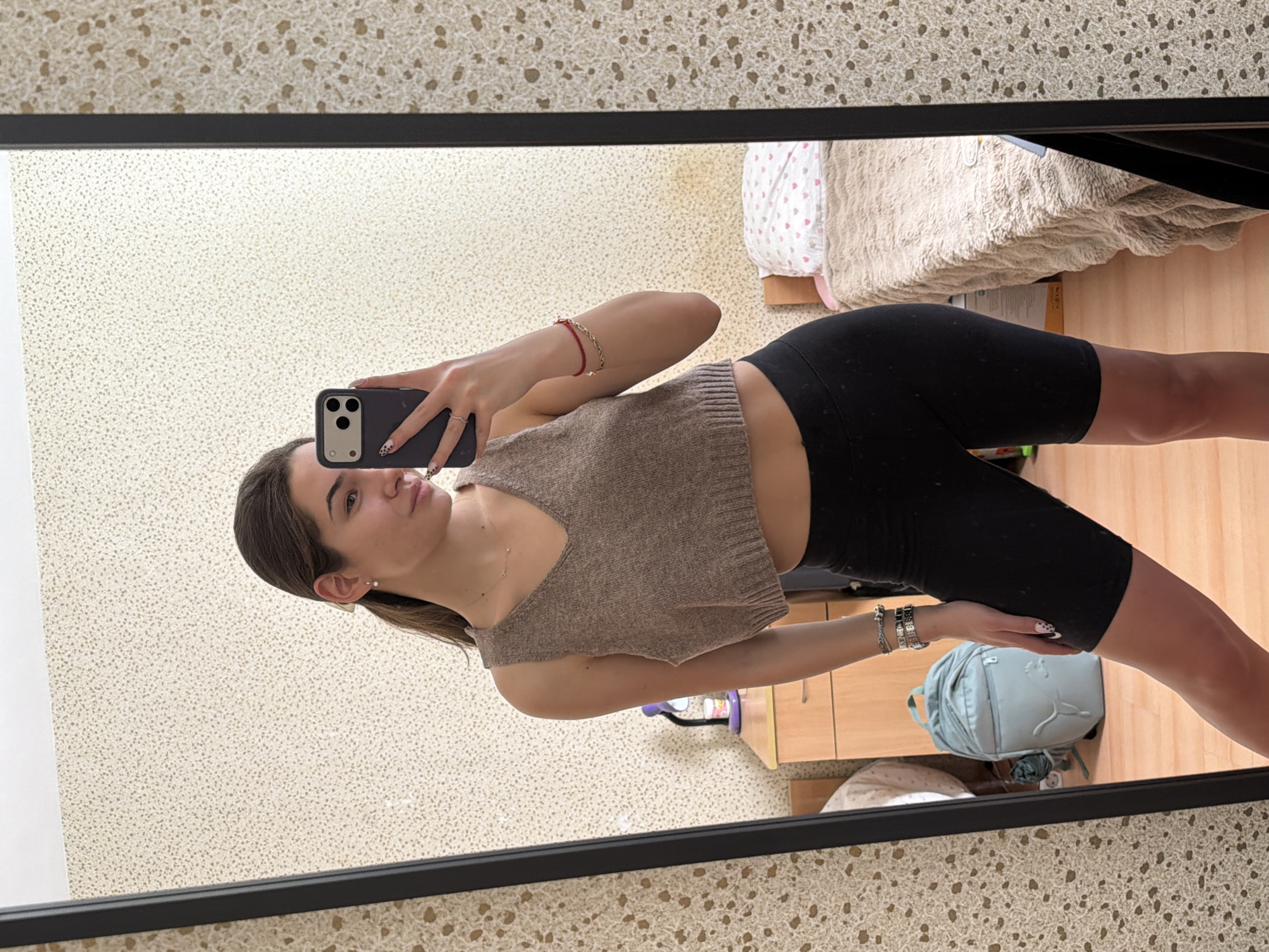 Woman takes mirror selfies in Sofia bedroom